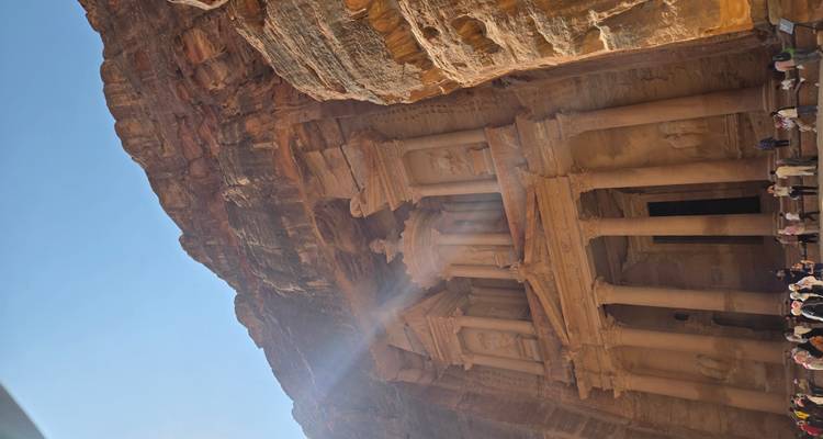 The Treasury in Petra with tourists gathered at the site.