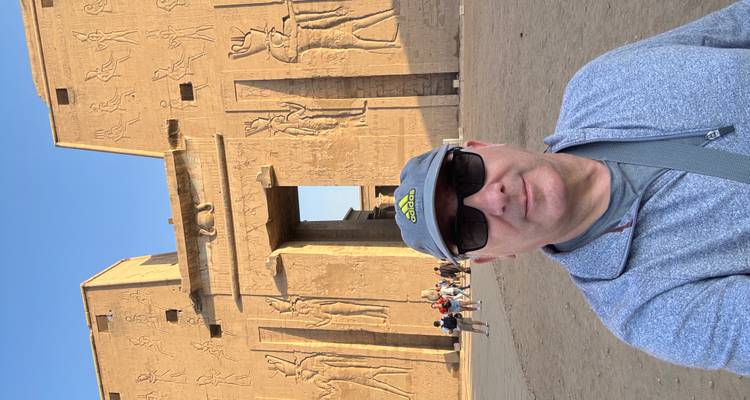 A person taking a selfie in front of an ancient Egyptian temple.