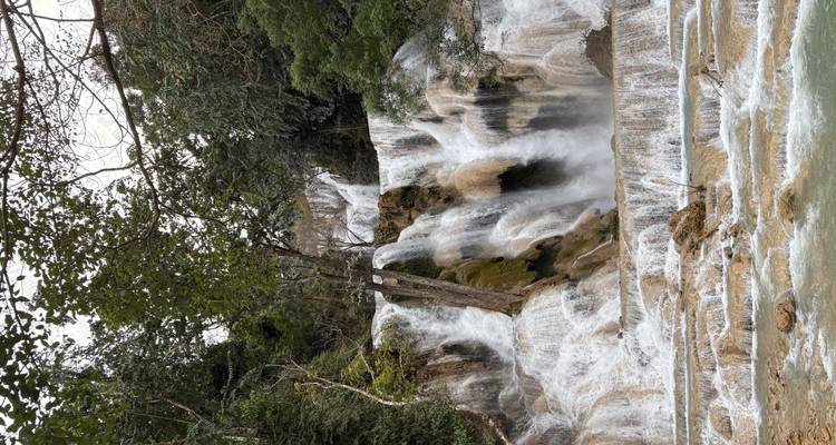Beautiful cascading waterfall surrounded by lush greenery.