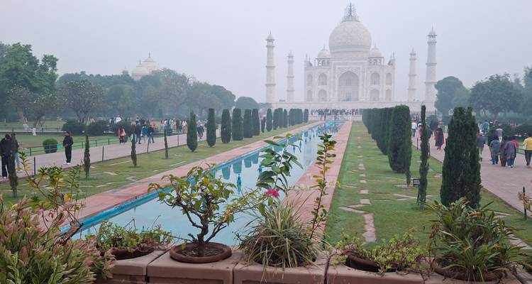 View of the Taj Mahal with gardens and reflection pool.