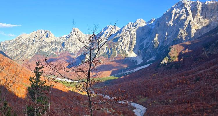 Vast mountain landscape with autumn foliage.