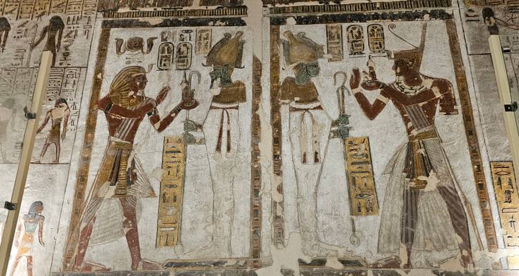 Intricate Egyptian wall carvings in a historical site.