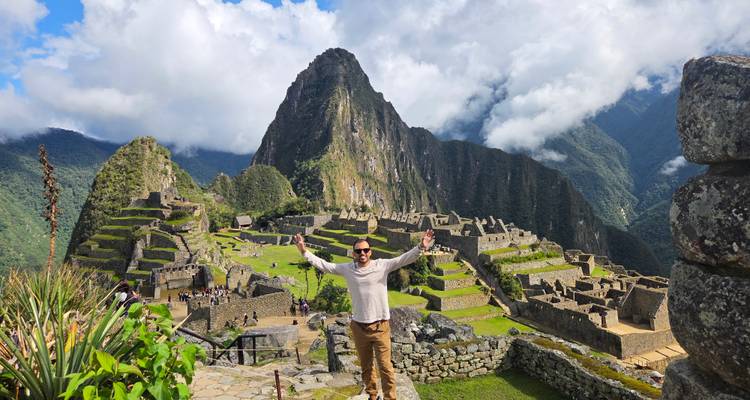 Person celebrating in front of Machu Picchu.
