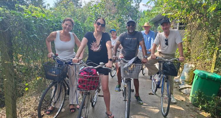 Group of tourists enjoying a bicycle ride through lush greenery.