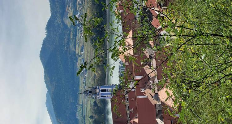 Vue pittoresque d'une ville avec rivière et clocher d'église.