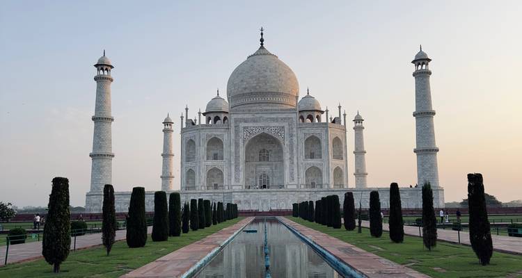 Classic frontal view of the Taj Mahal reflected in the long water channel at dawn