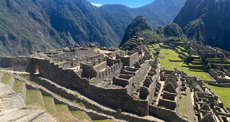 Classic wide view of Machu Picchu’s stone ruins cascading down green terraces against jungle peaks