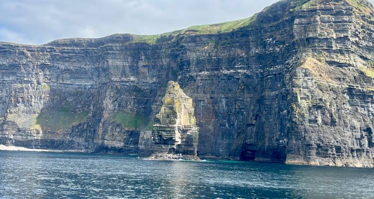 Sheer sea cliffs rising above the Atlantic with turquoise water below.