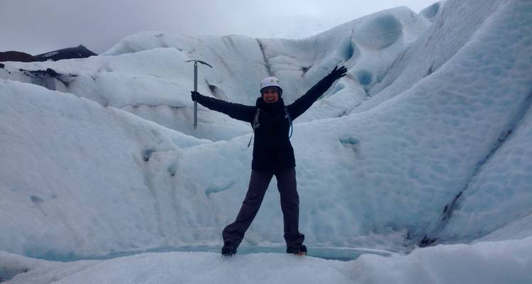 Personne posant avec un piolet dans une zone glaciaire.