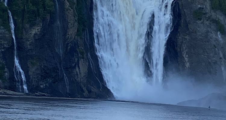 Large waterfall with a bridge above.