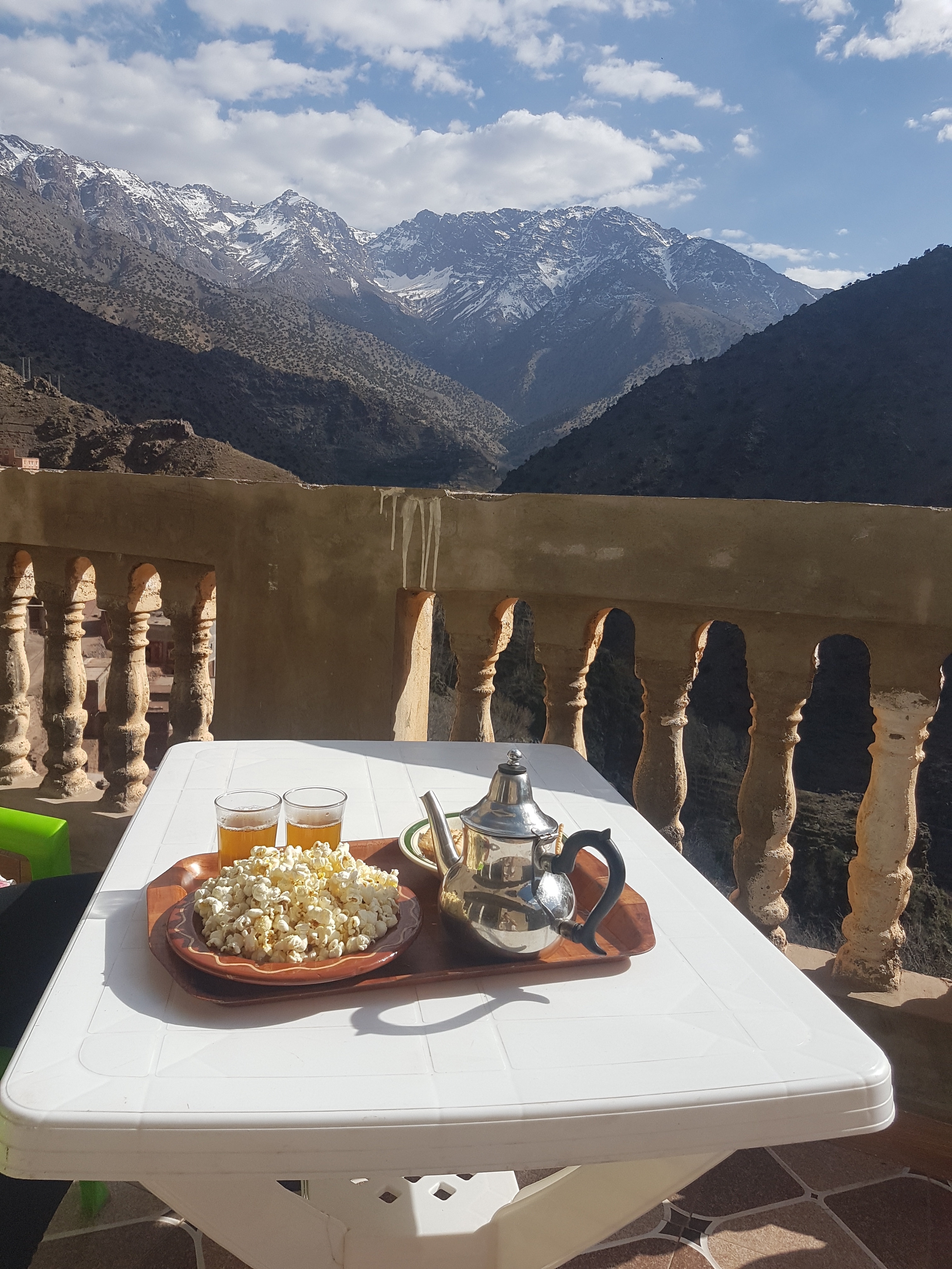 Mountain view from a terrace with tea set and snacks