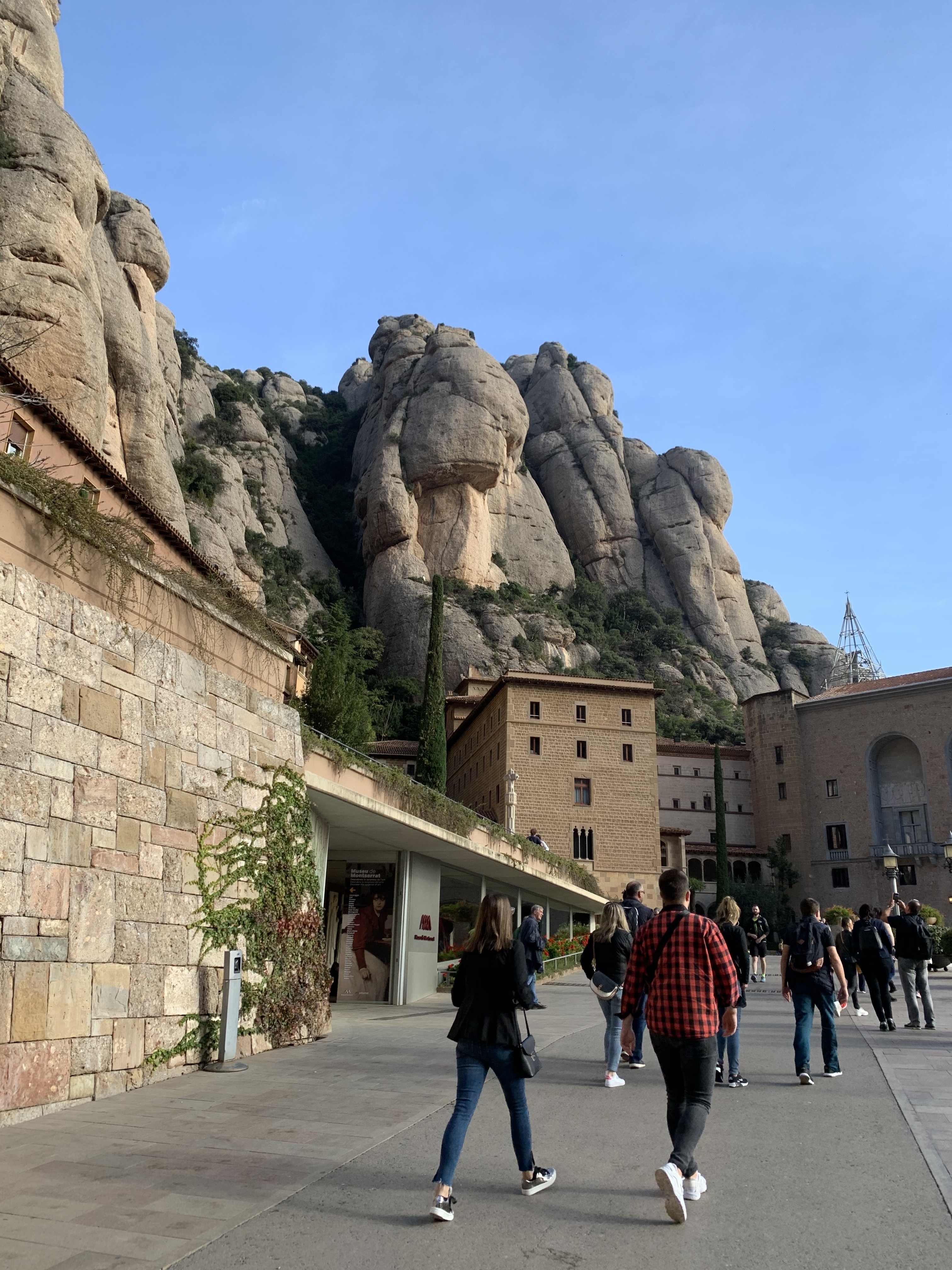 Building facade against a rugged mountain backdrop.
