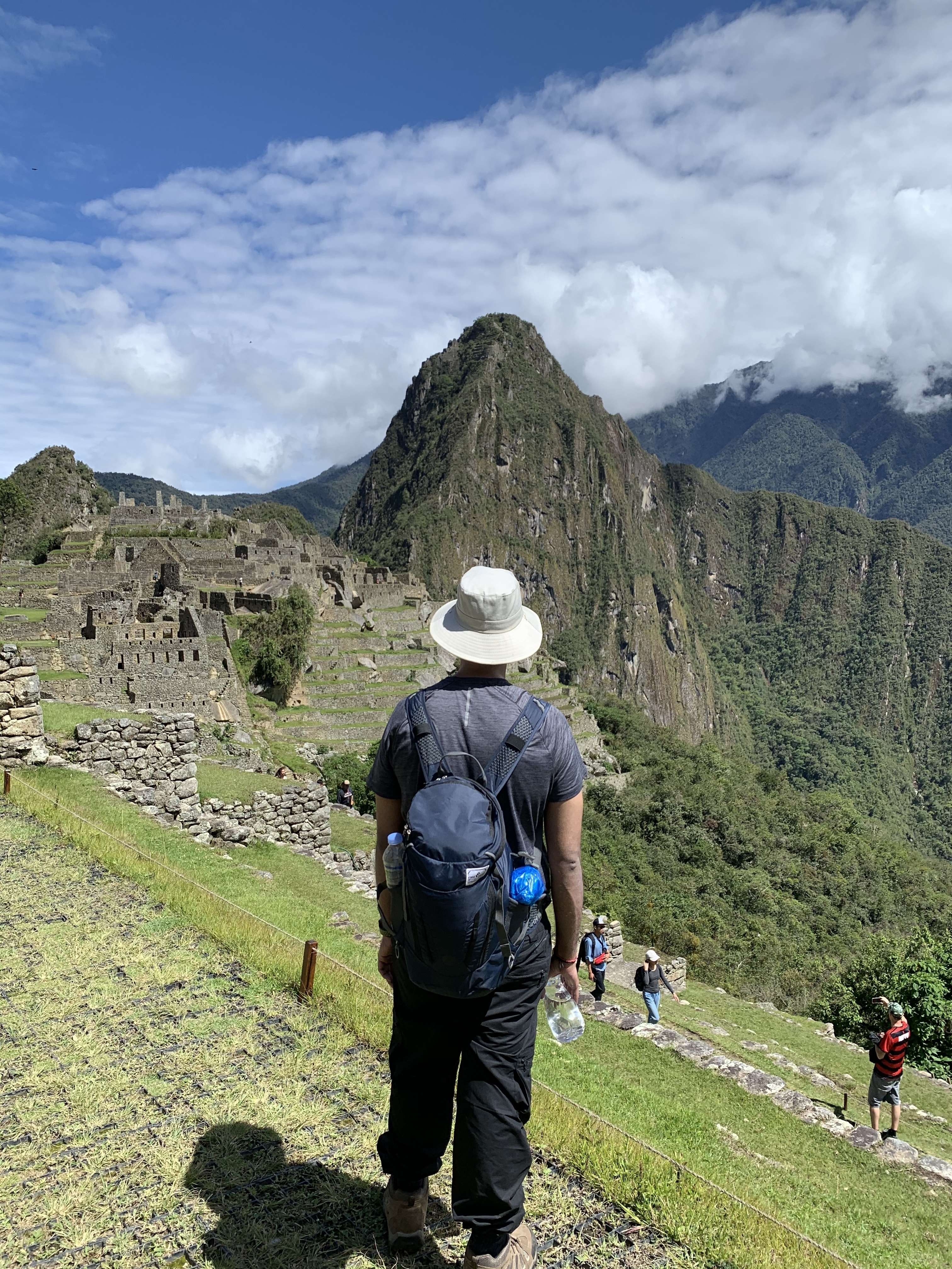 Person standing with a view of Machu Picchu