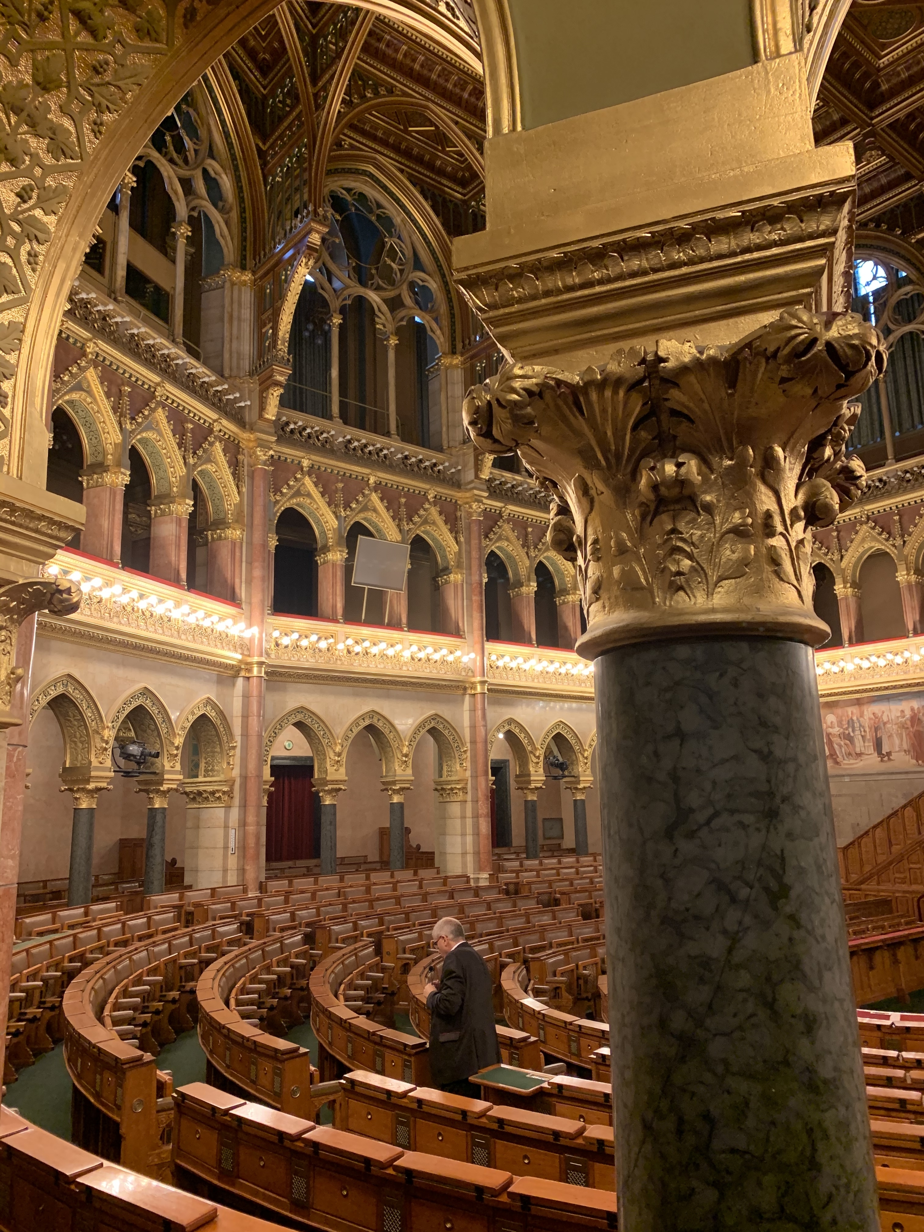 Luxurious interior of a grand hall with ornate columns and arches.