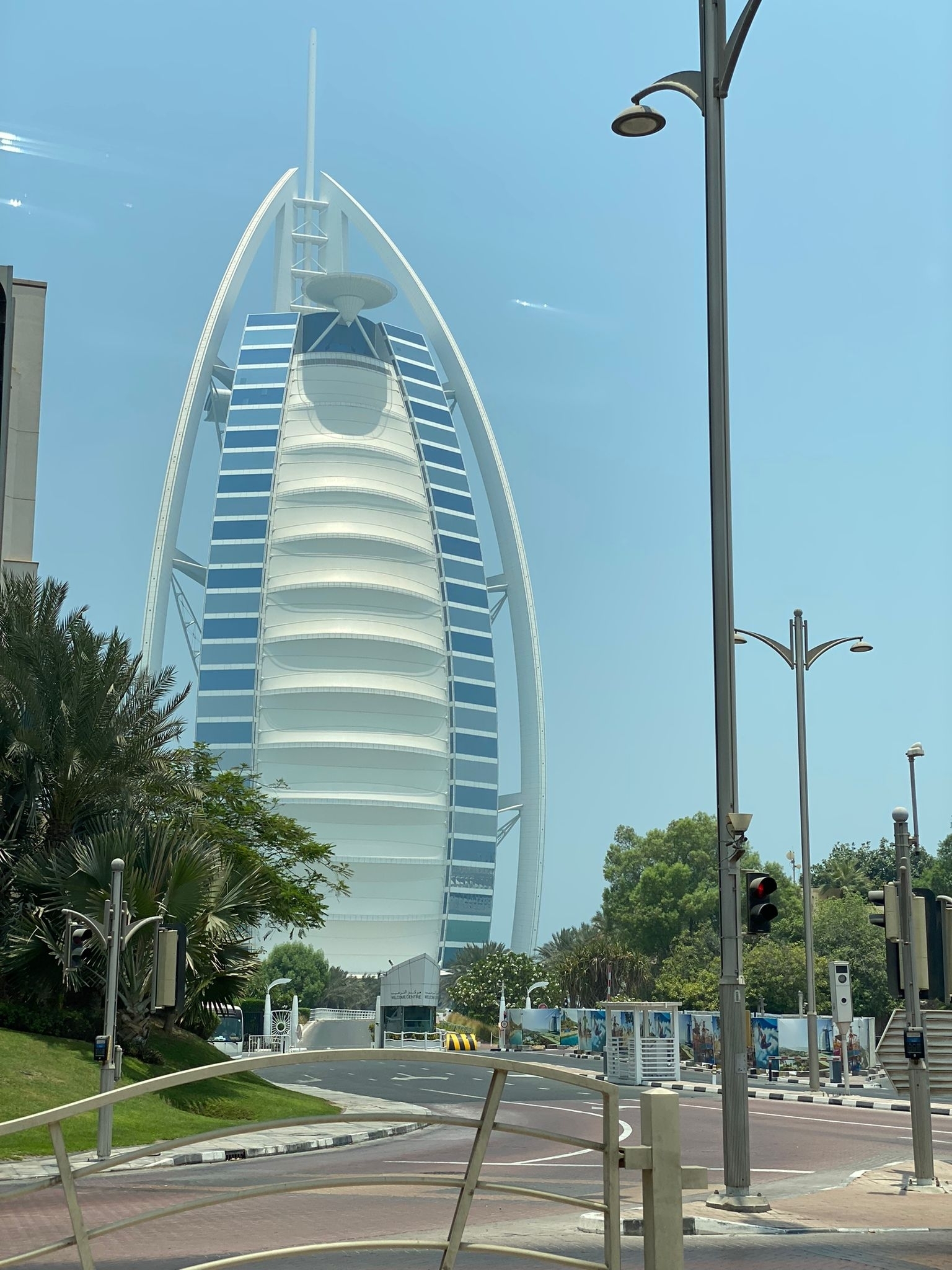 Famous sail-shaped hotel building surrounded by greenery.