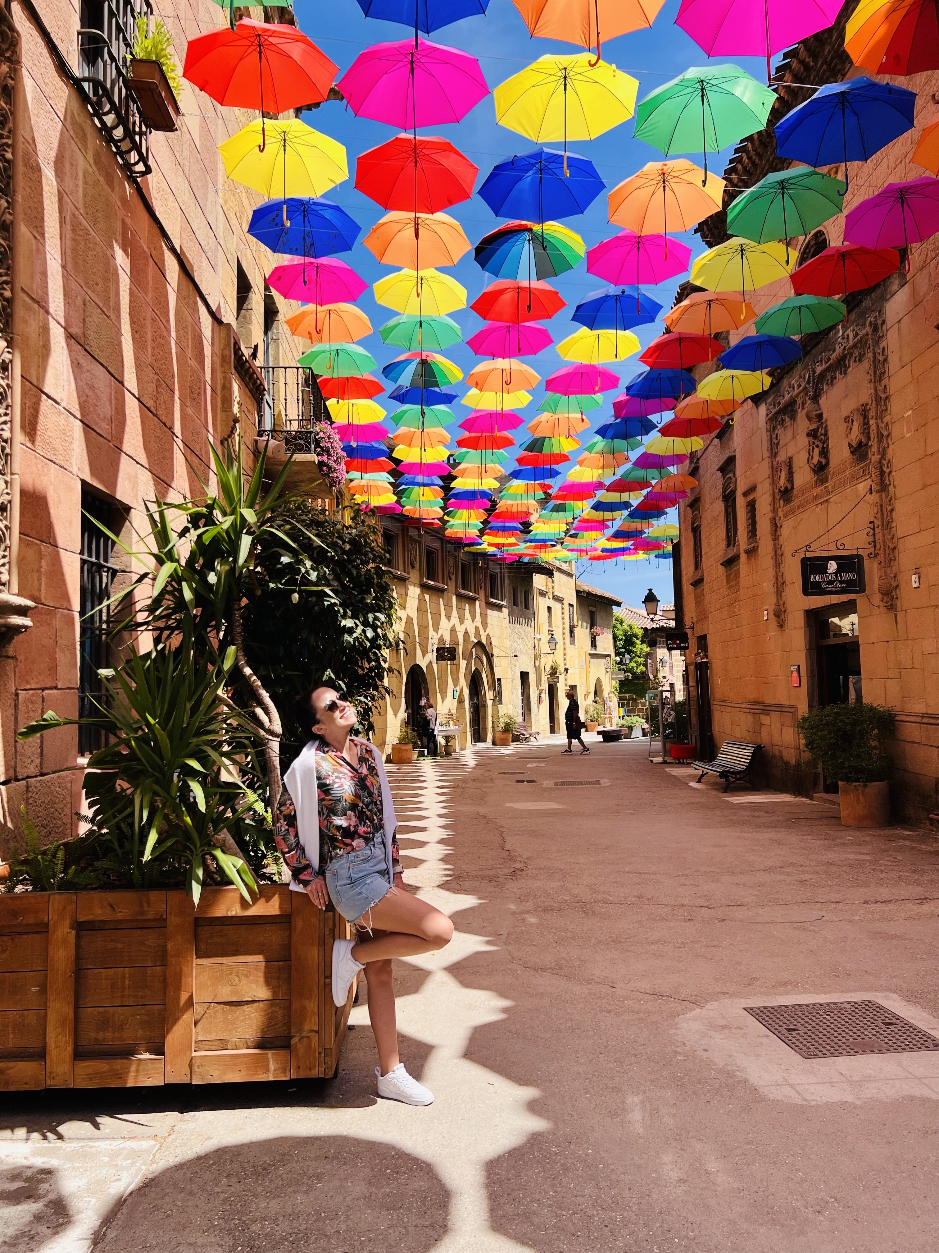 Colorful umbrellas hanging over a quaint street