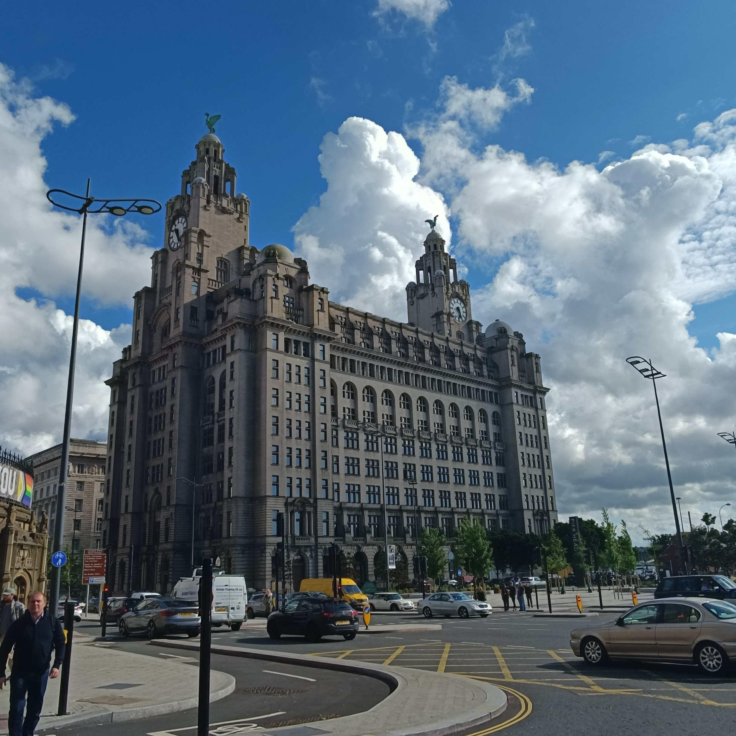 A historical building with towers against a cloudy sky.