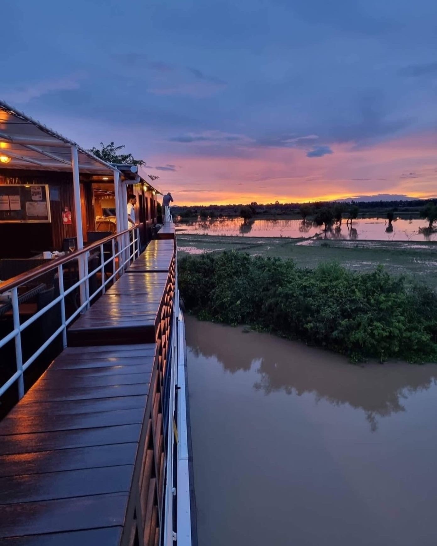 Sunset view from a boat overlooking floodplains.