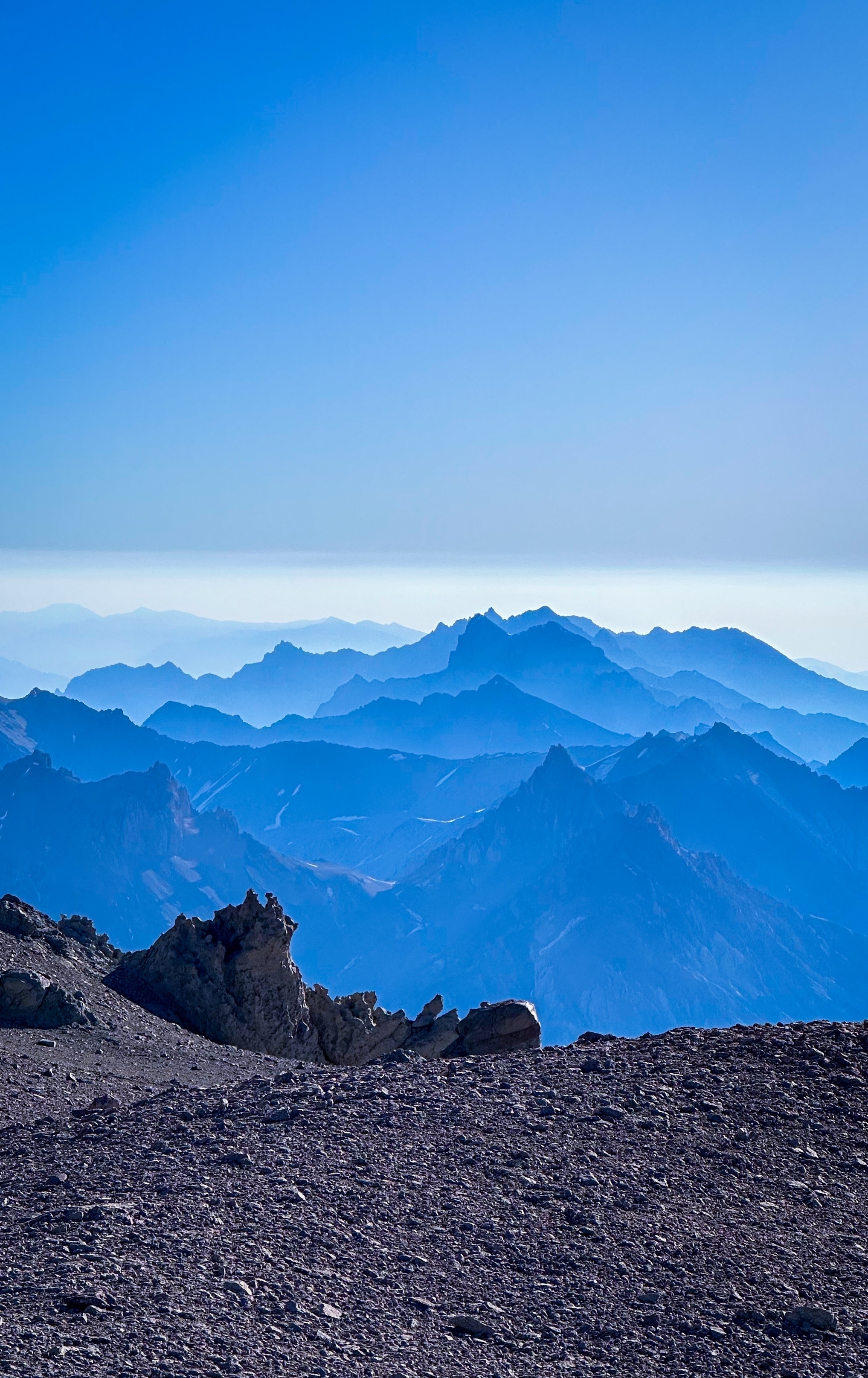 Layers of distant mountain ranges in varying shades of blue.