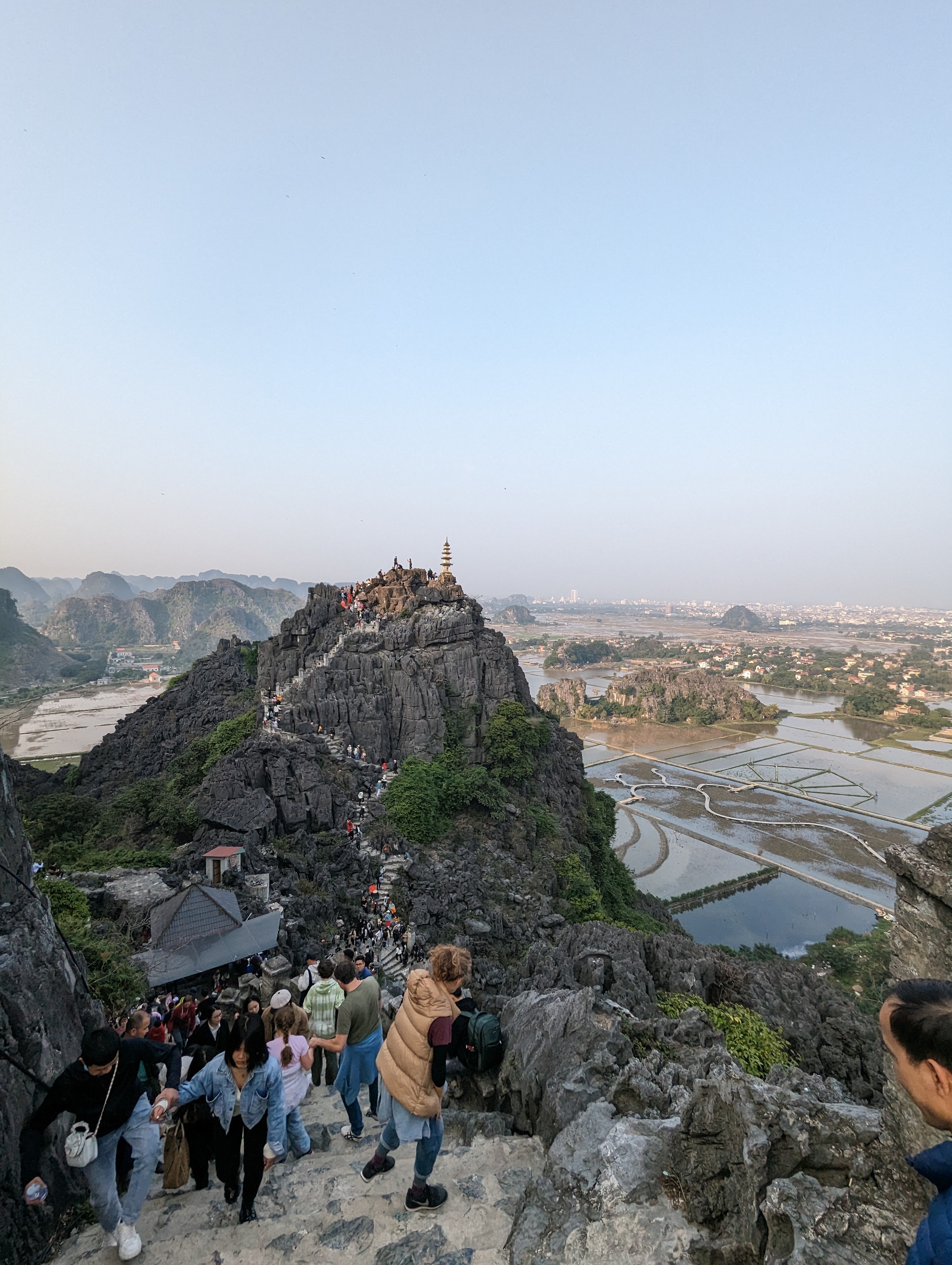 Dramatic mountain landscape with a distant city view.