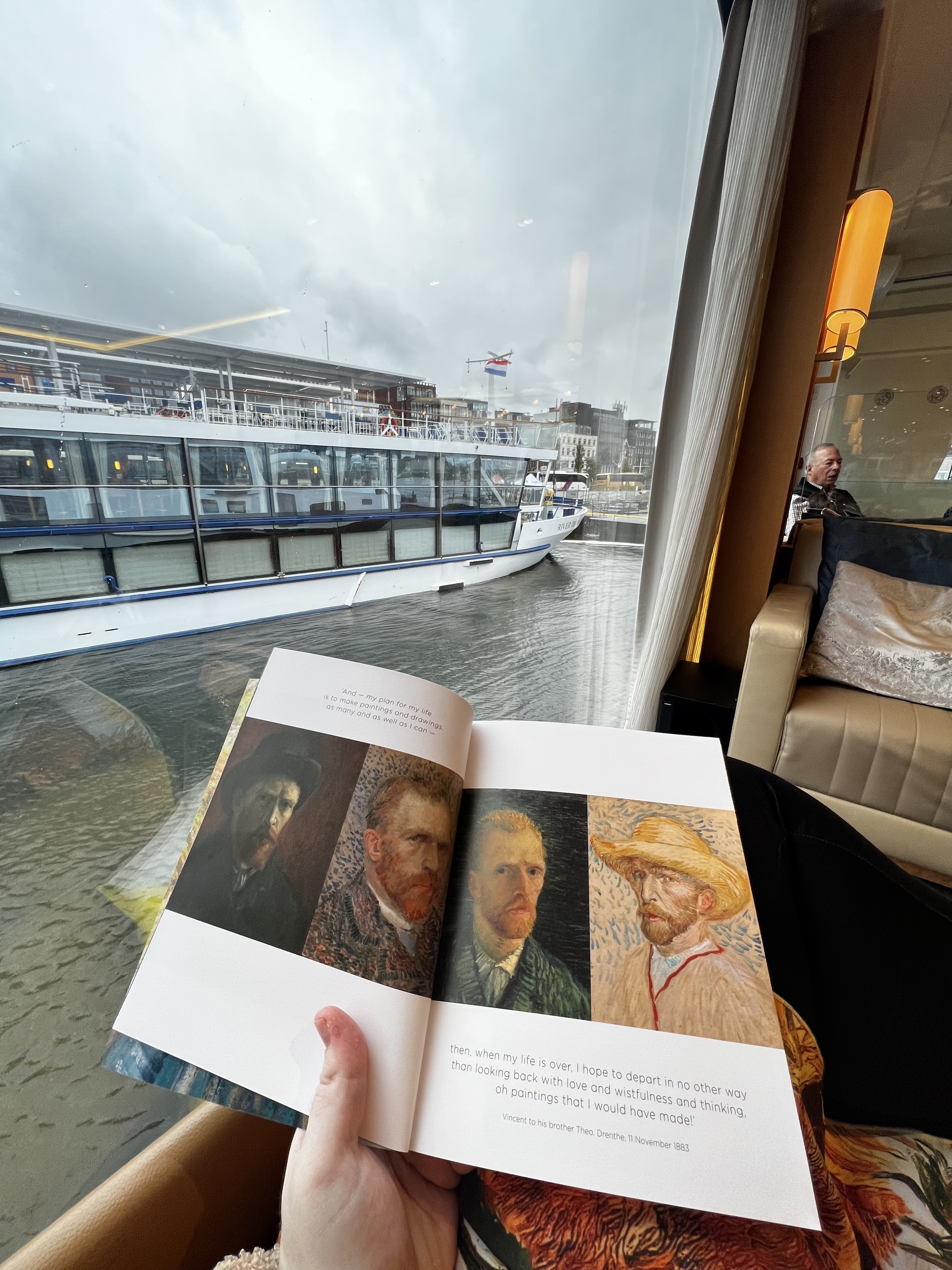 A book and the view of a boat through a window.