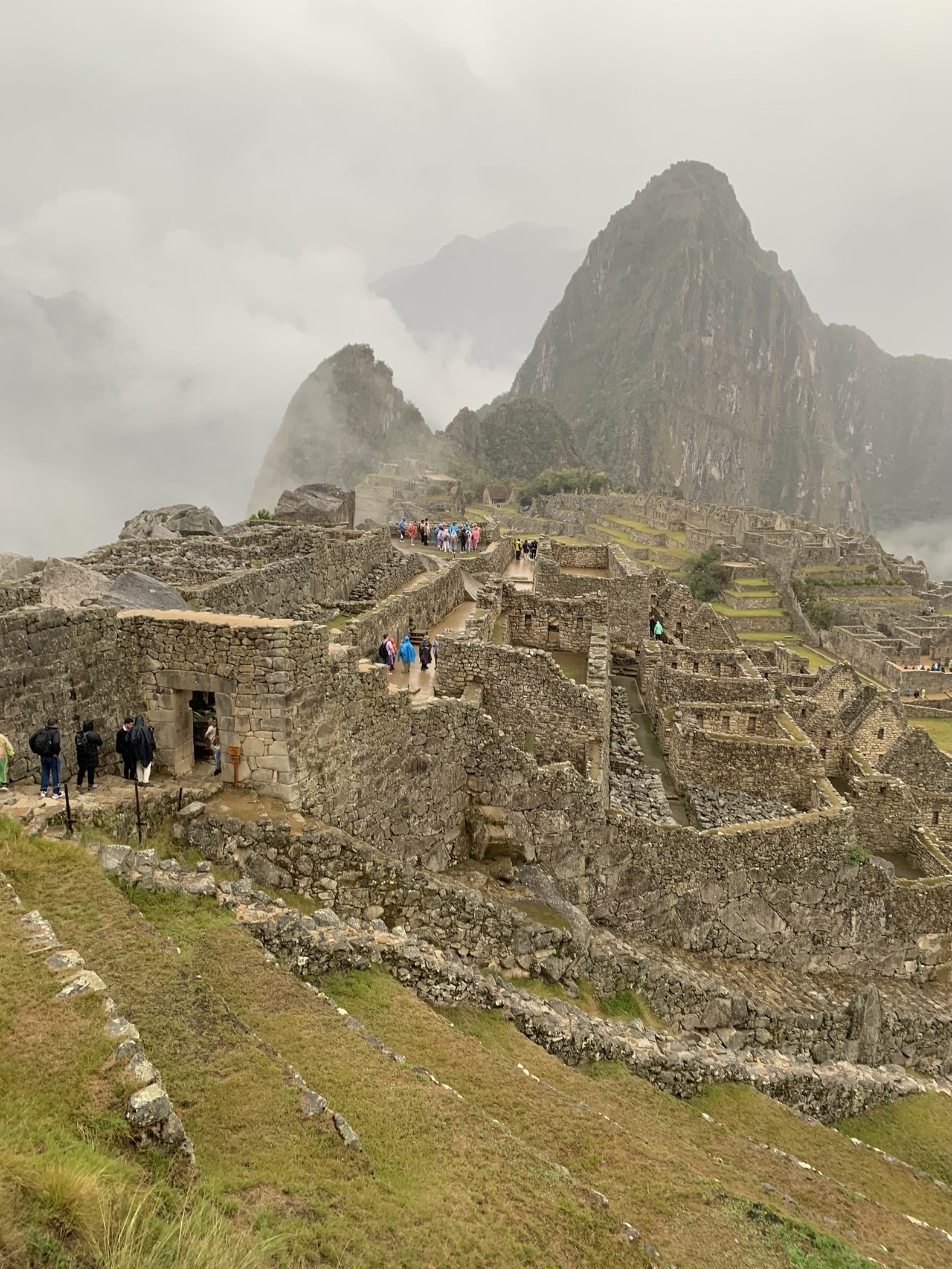 Machu Picchu ruins with tourists exploring.
