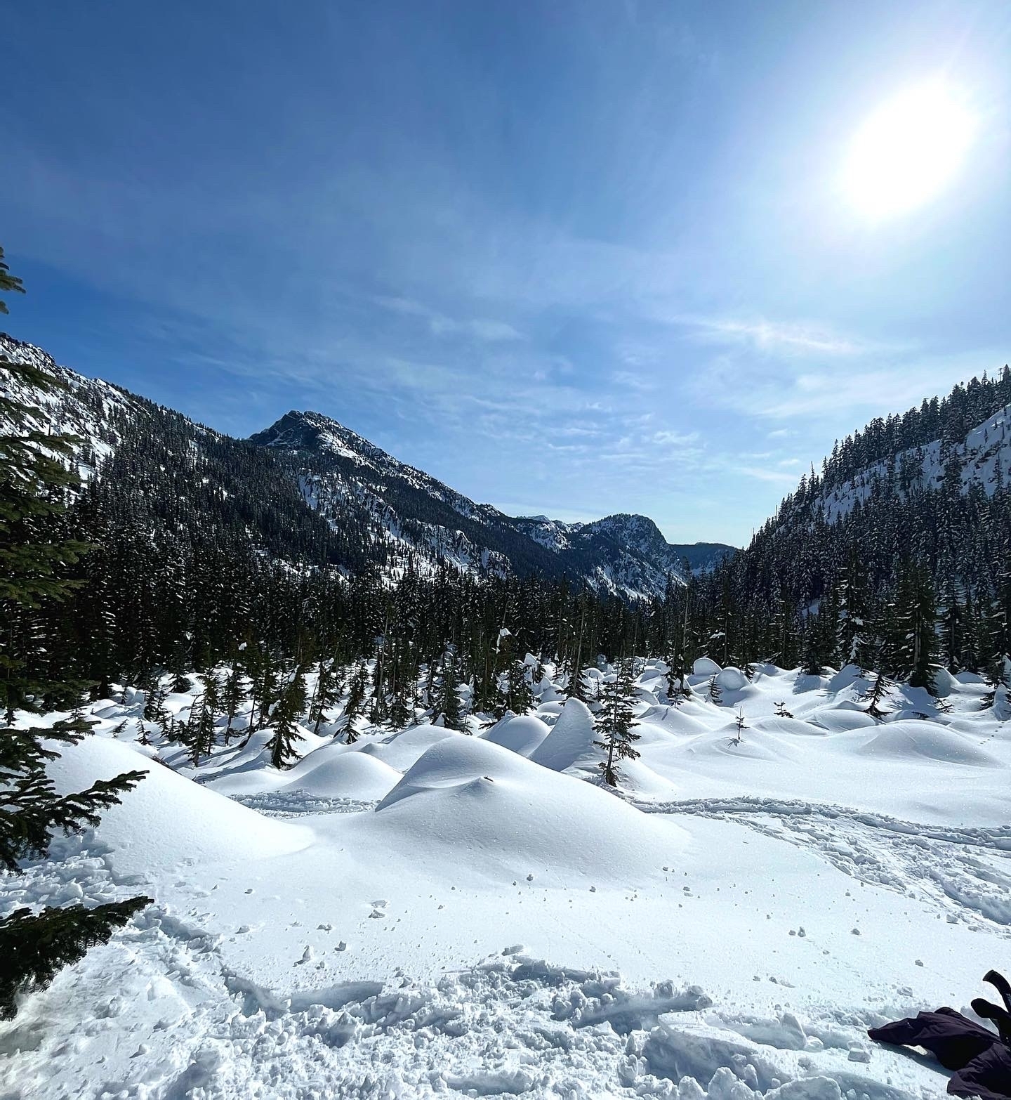 Snowy mountain landscape with a clear blue sky.