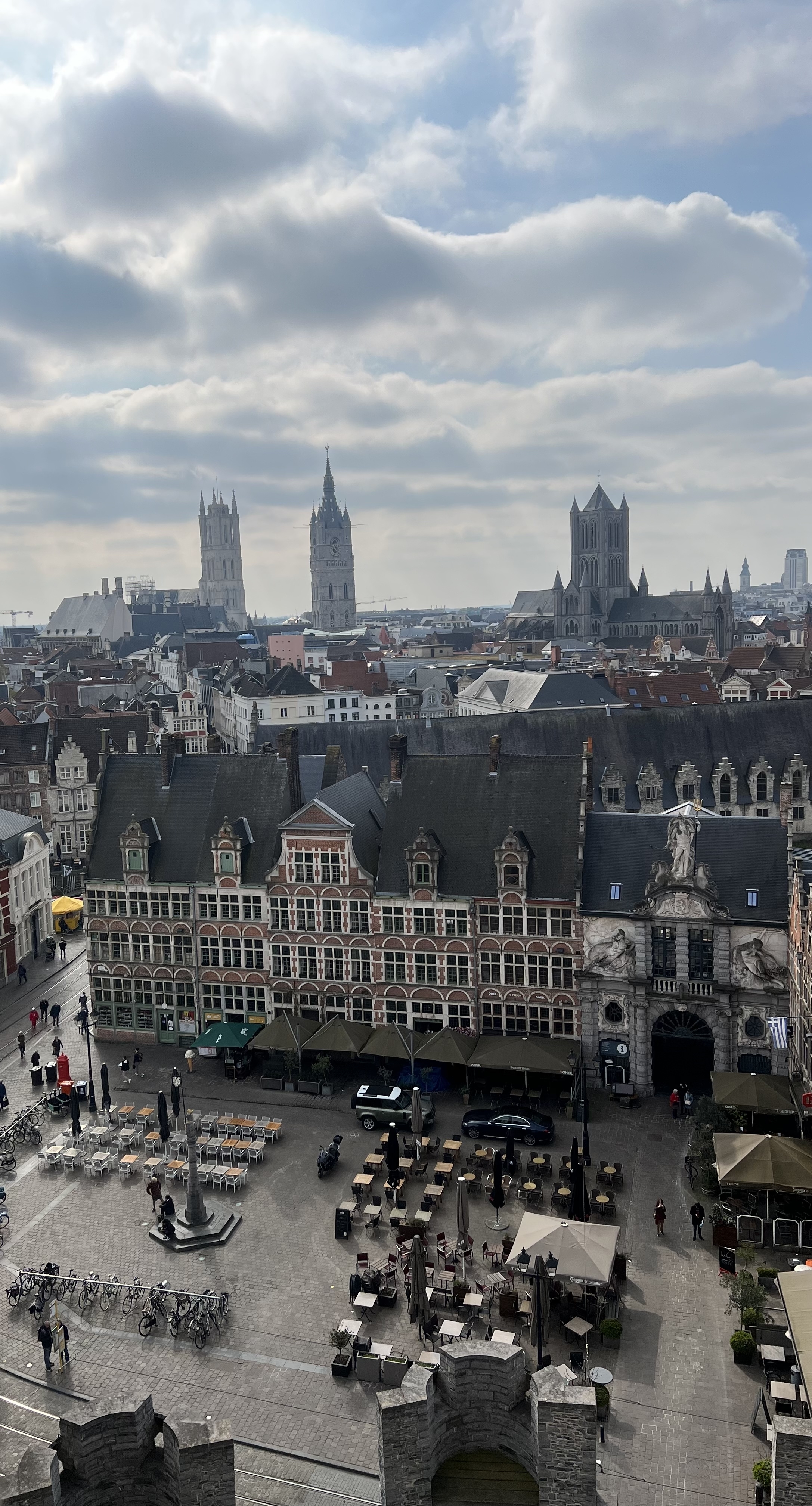 Panoramic city view with historic buildings and church spires.