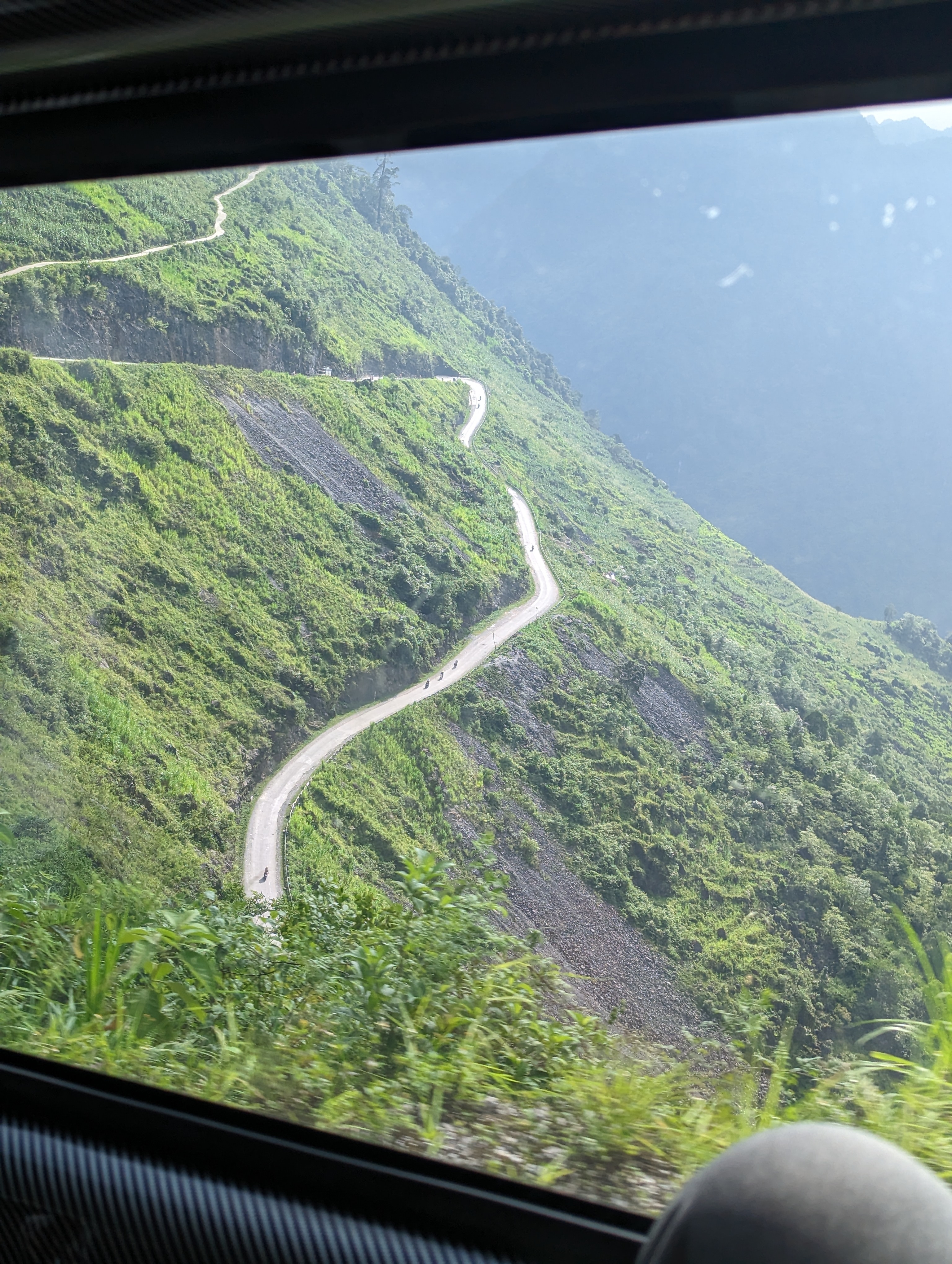 Snaking road on a lush green mountain side.
