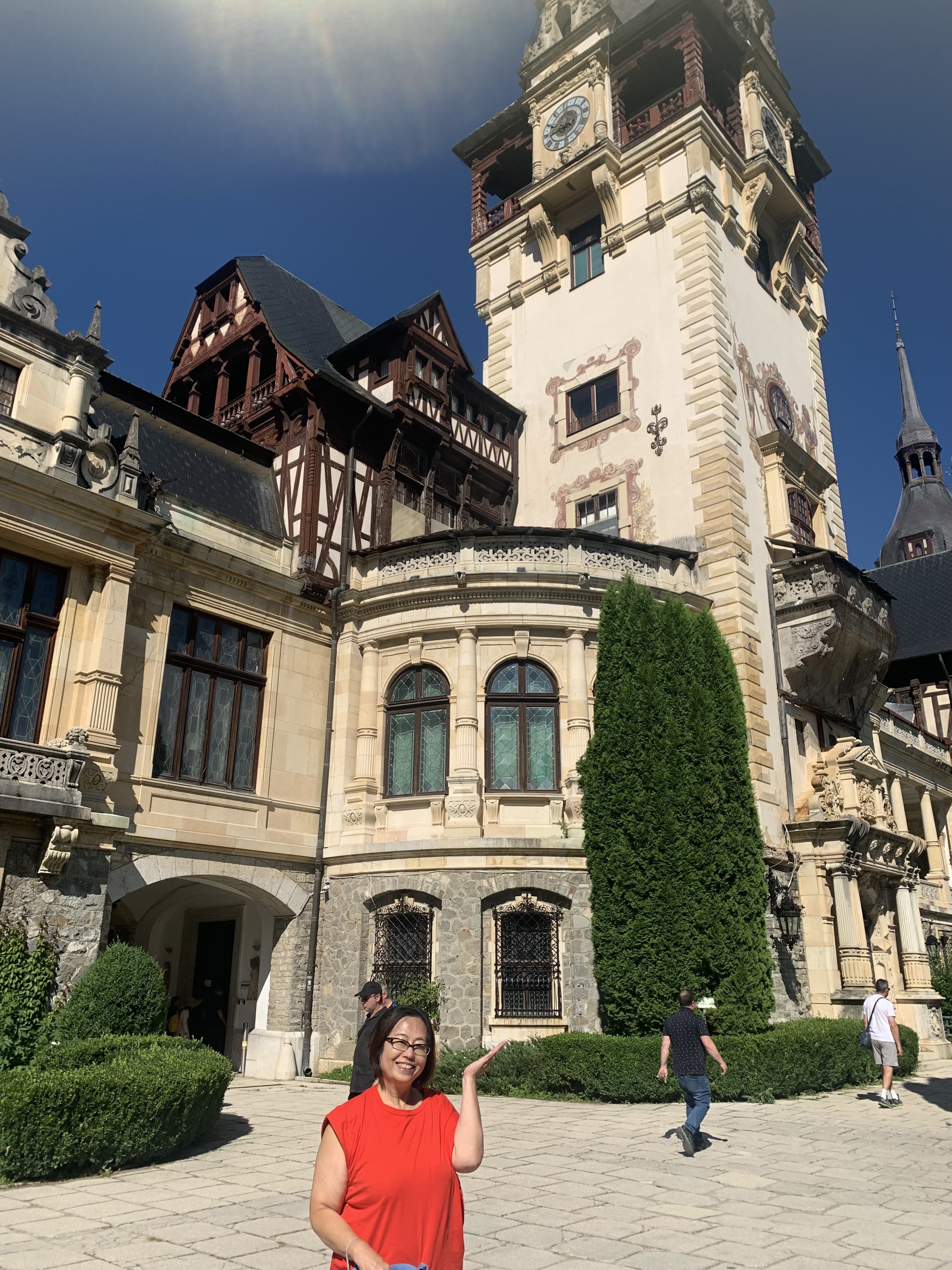 View of Peles Castle with detailed architecture and greenery.