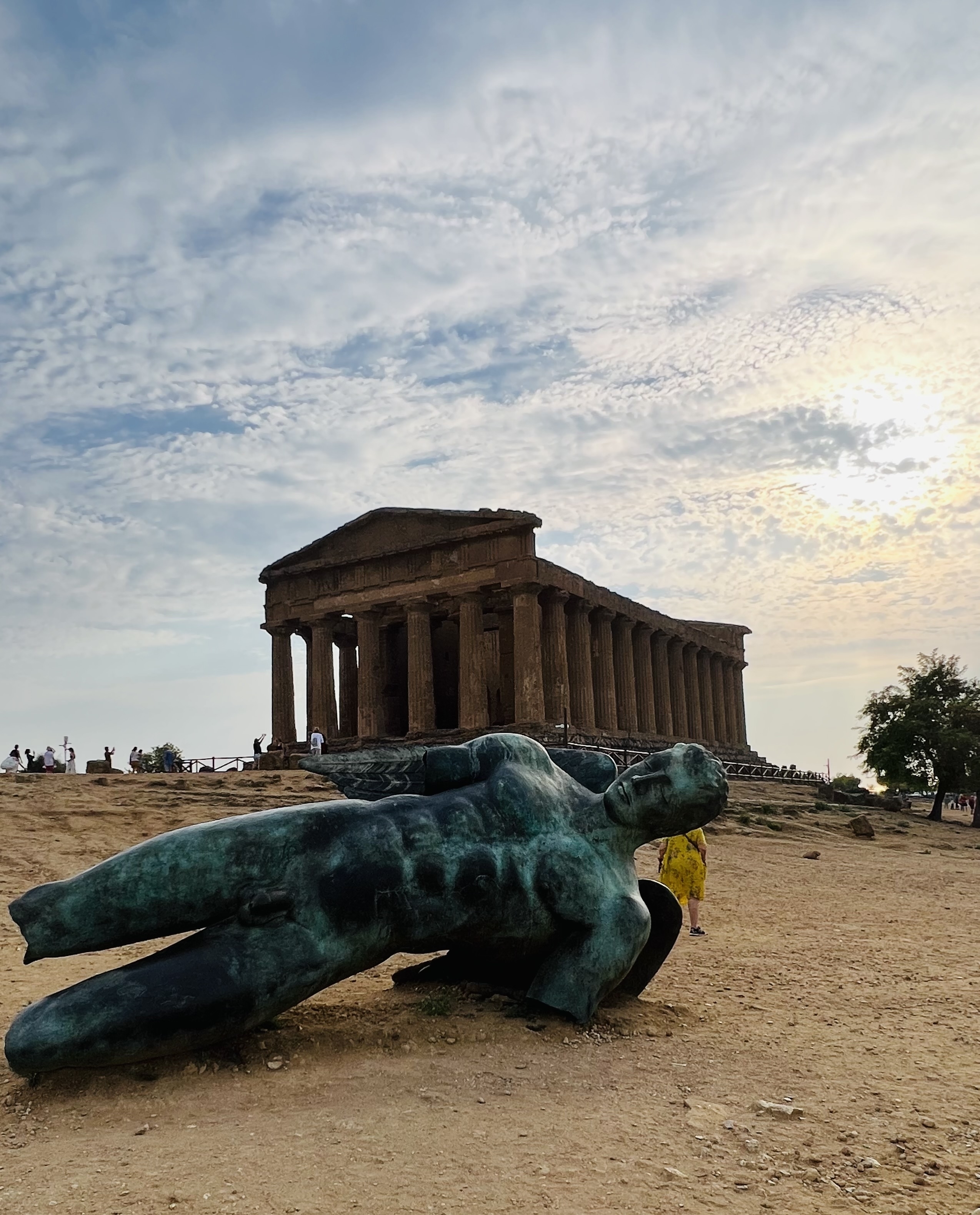 Ancient temple ruins with sculpture of a reclining figure.