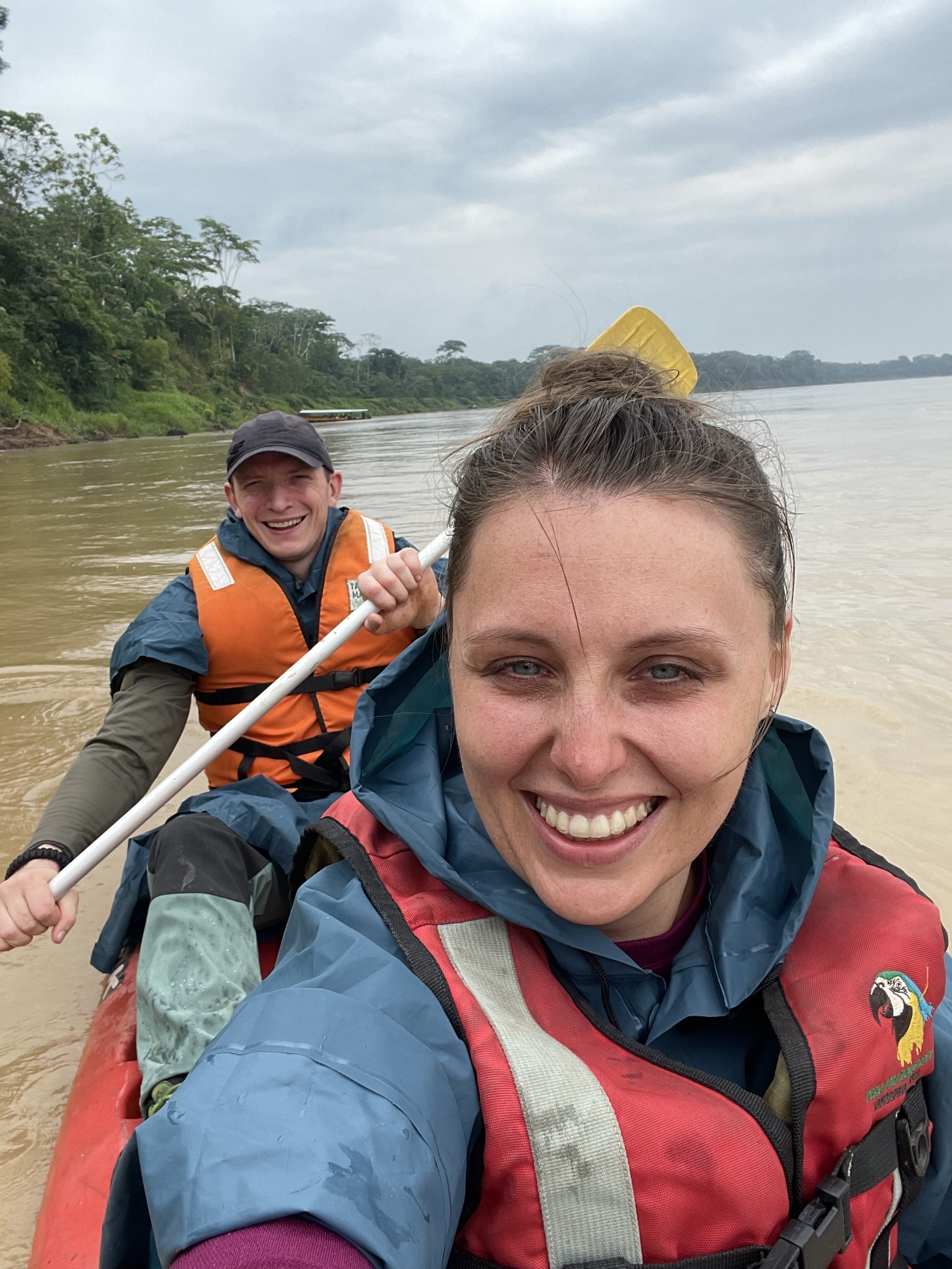Two people canoeing in a river.