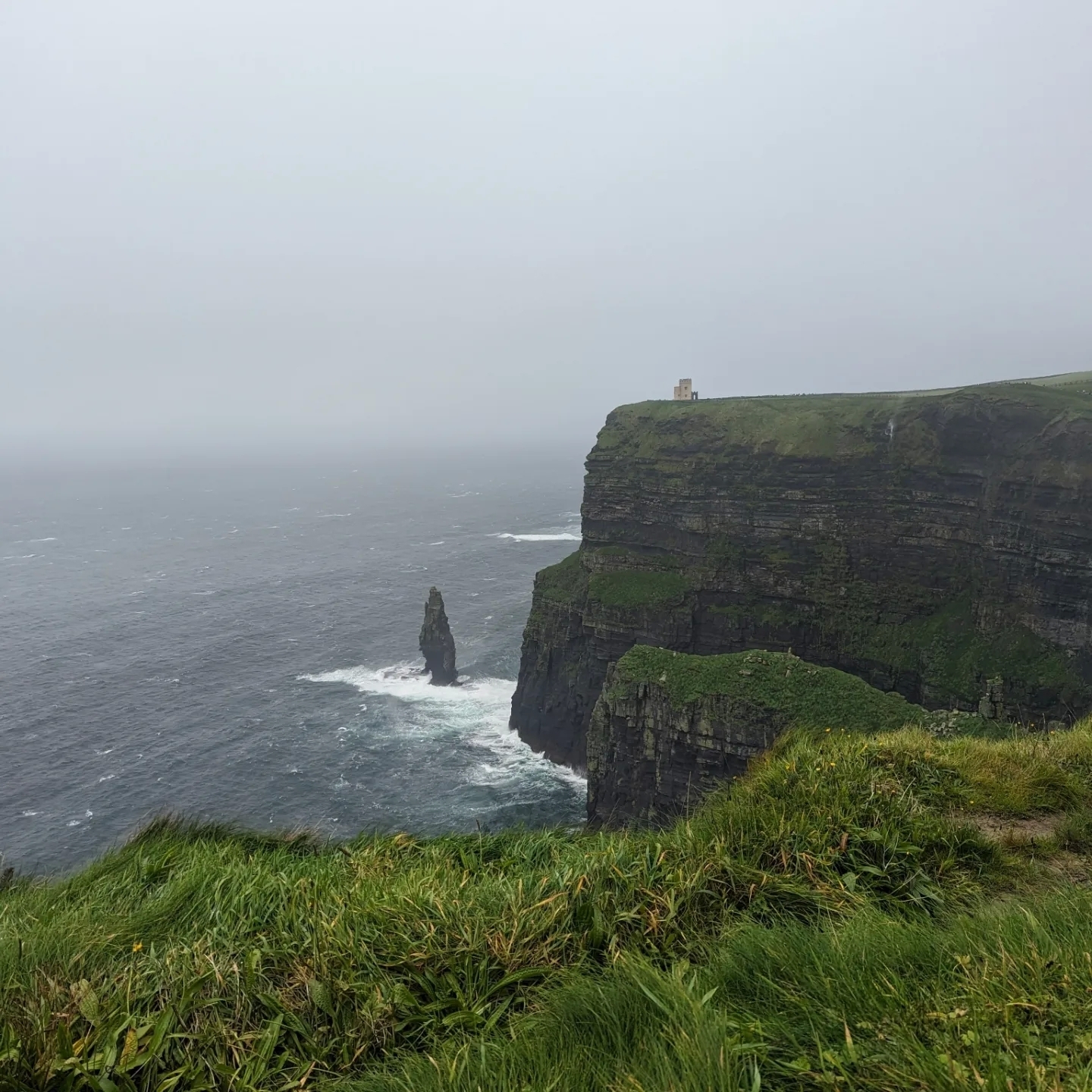 Iconic tall cliffs meeting rough sea waters.