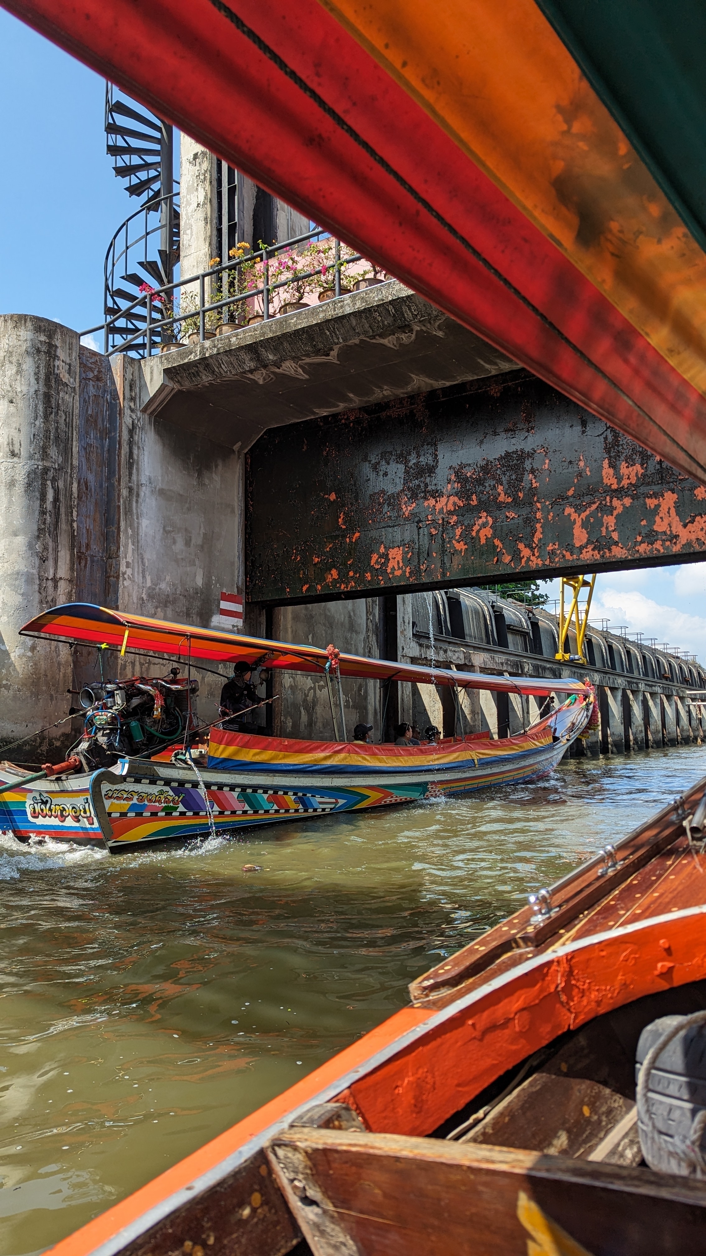 Colorful boat navigating a narrow canal.