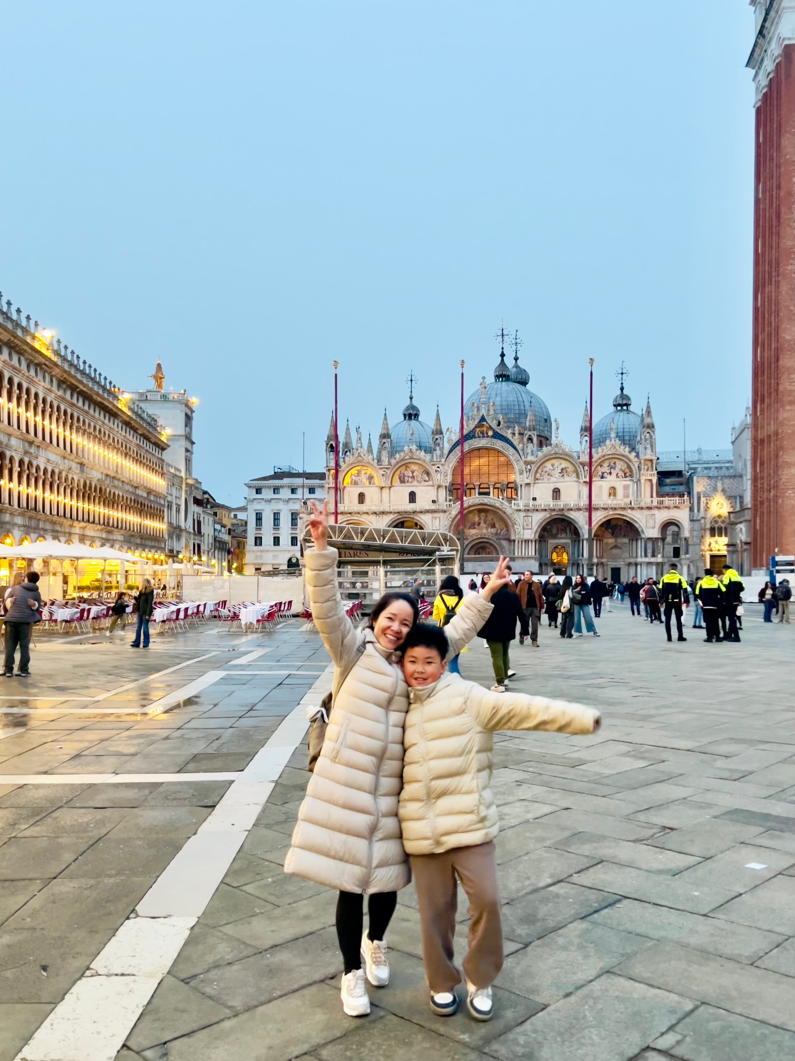 Tourists posing with St. Mark's Basilica in the background