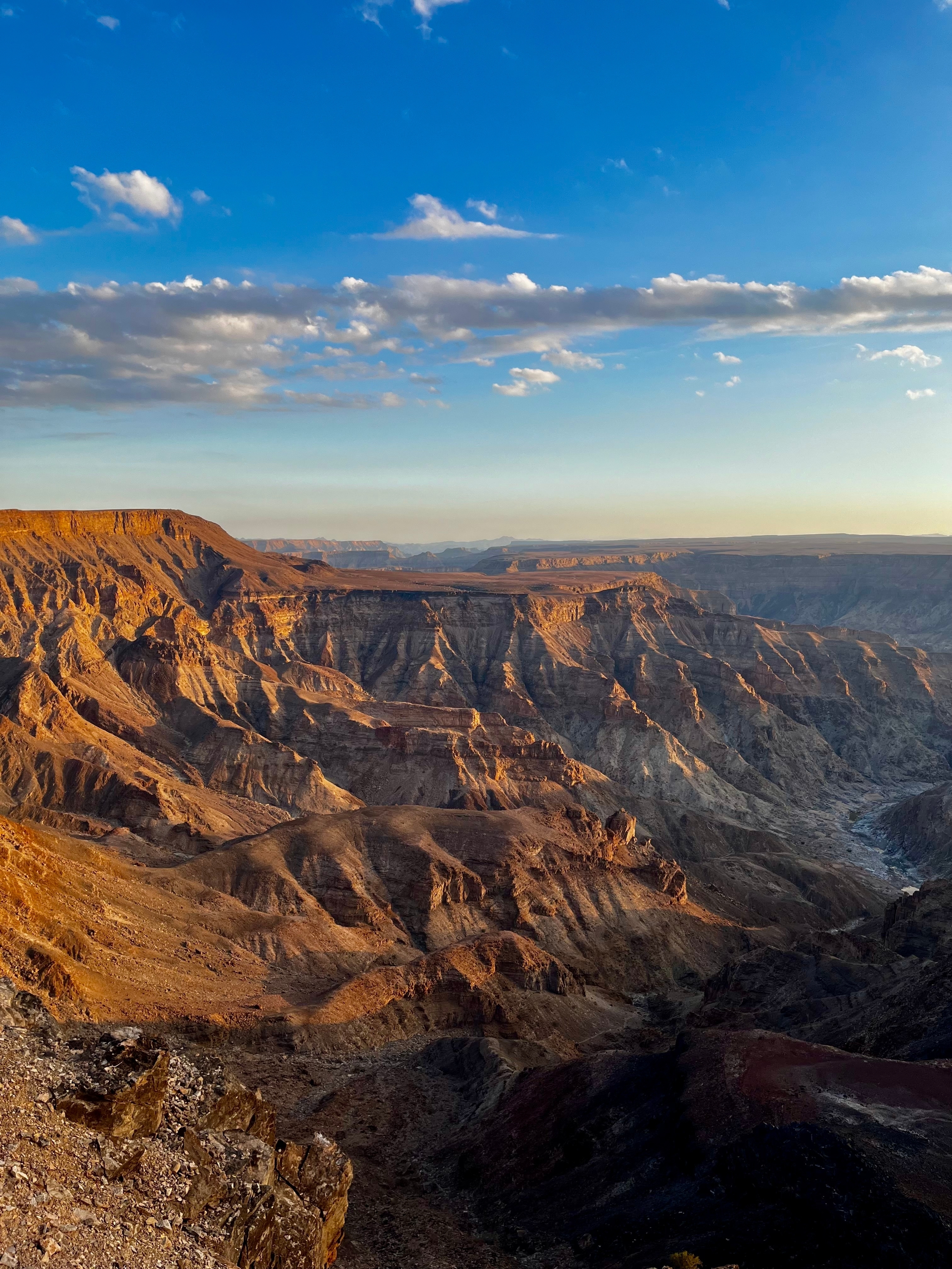 The grand canyon landscape with dramatic rock formations at sunset.