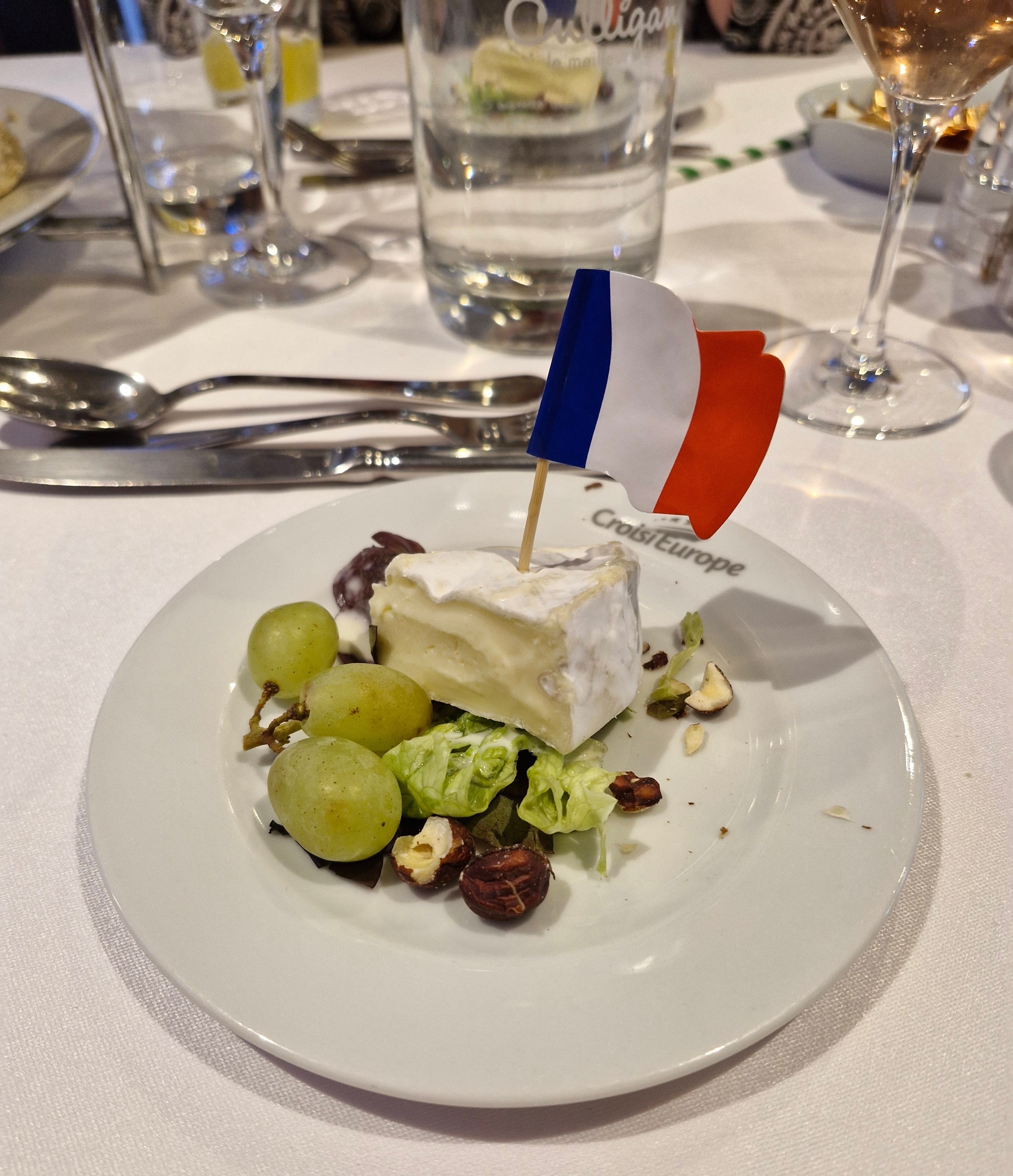 Plate of cheese and grapes with a French flag