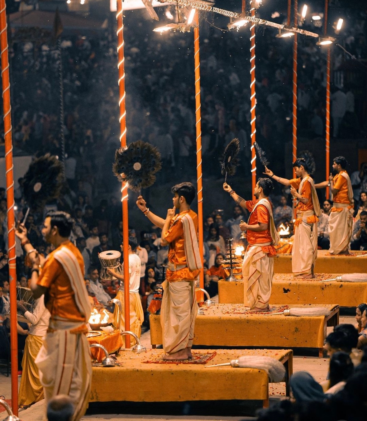 People performing a ceremony with lit up surroundings.