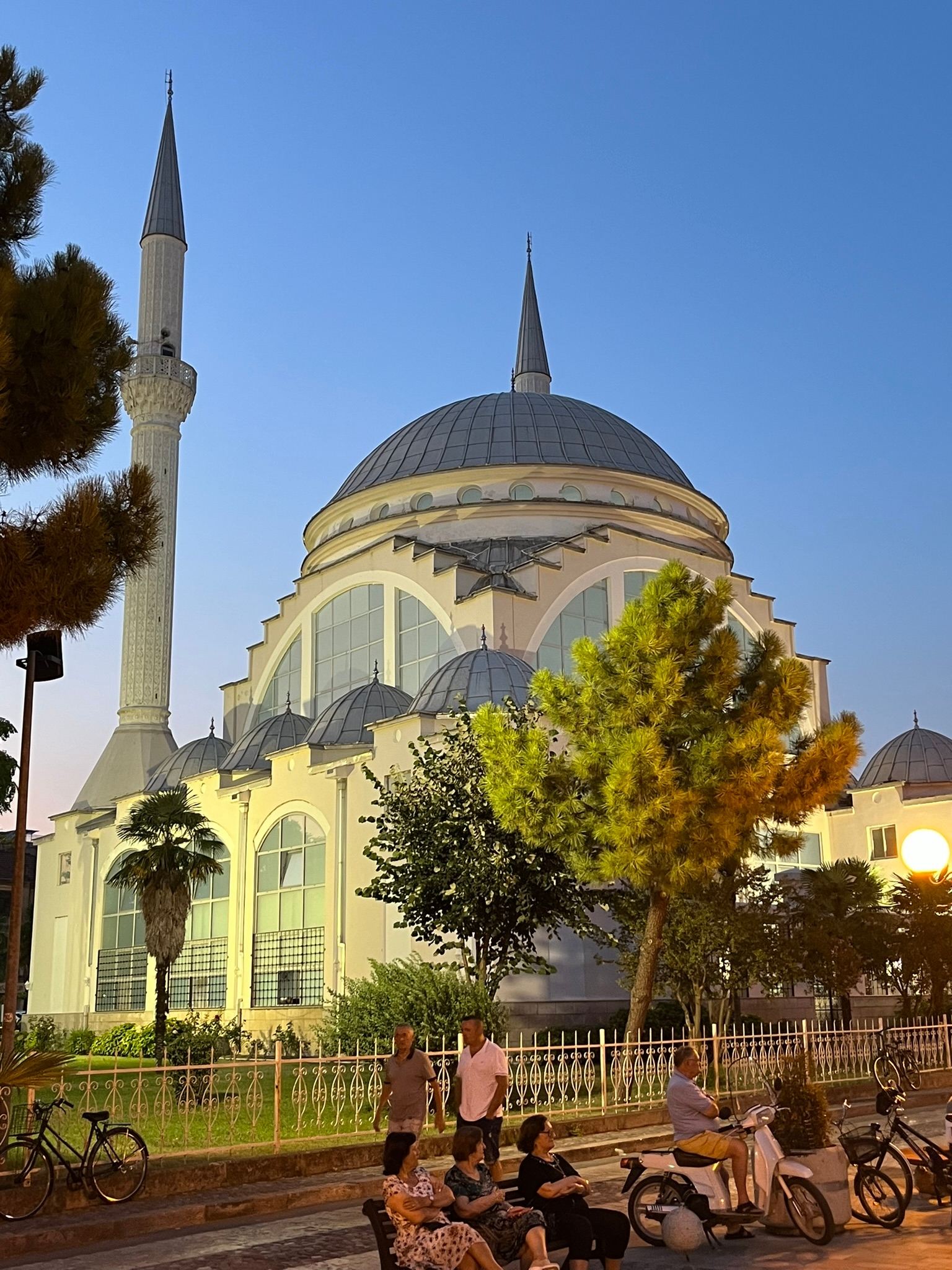 Dome mosque building with decorative lights at night.