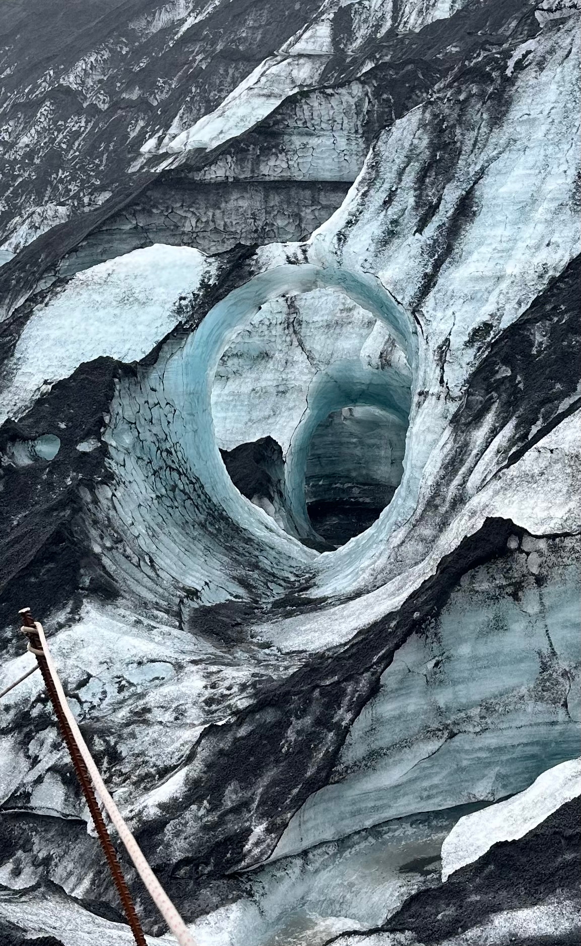 An ice cave with intricate patterns of light and shadows.