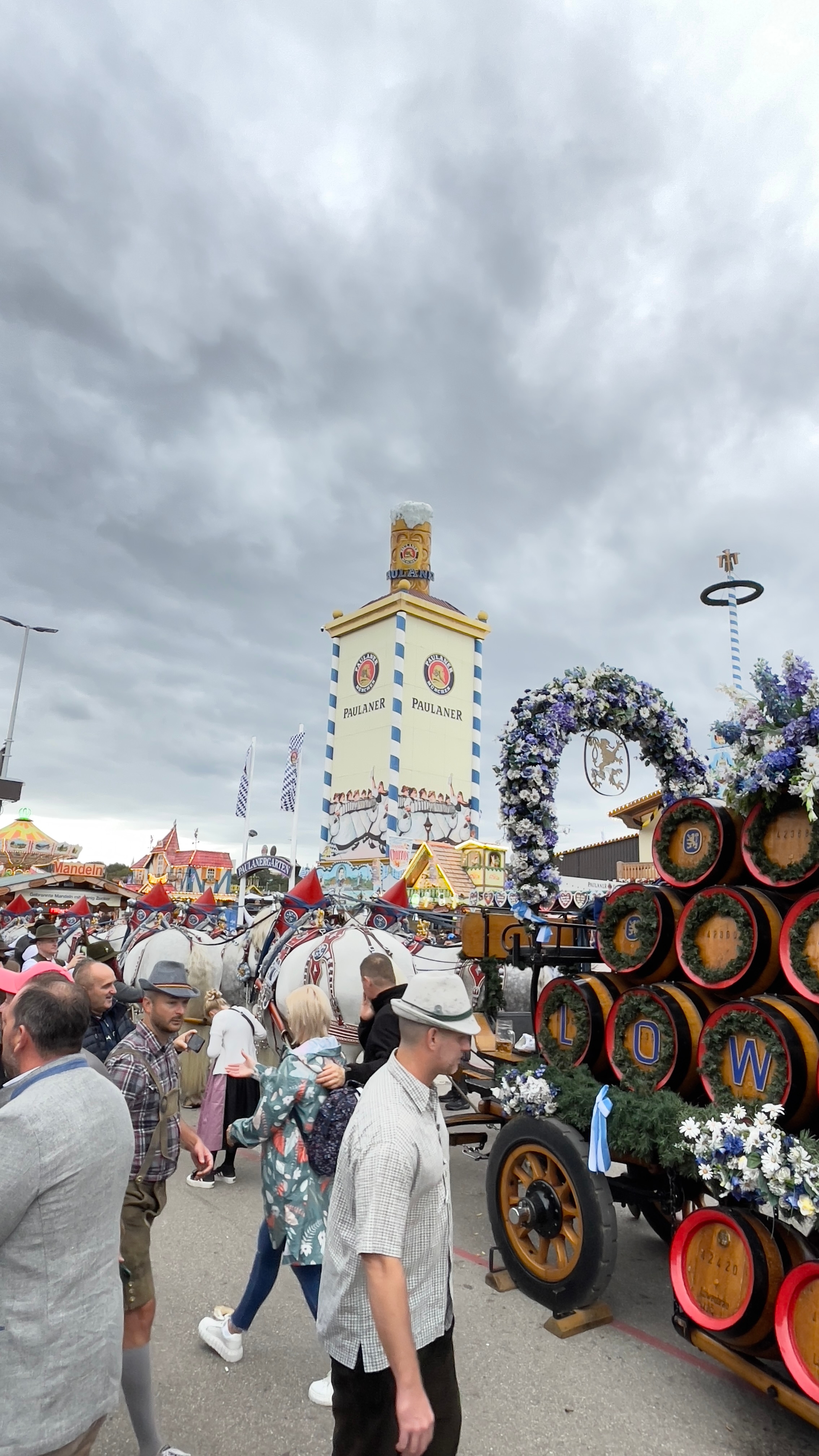 Oktoberfest celebration with Paulaner Tower and beer barrel decorations.