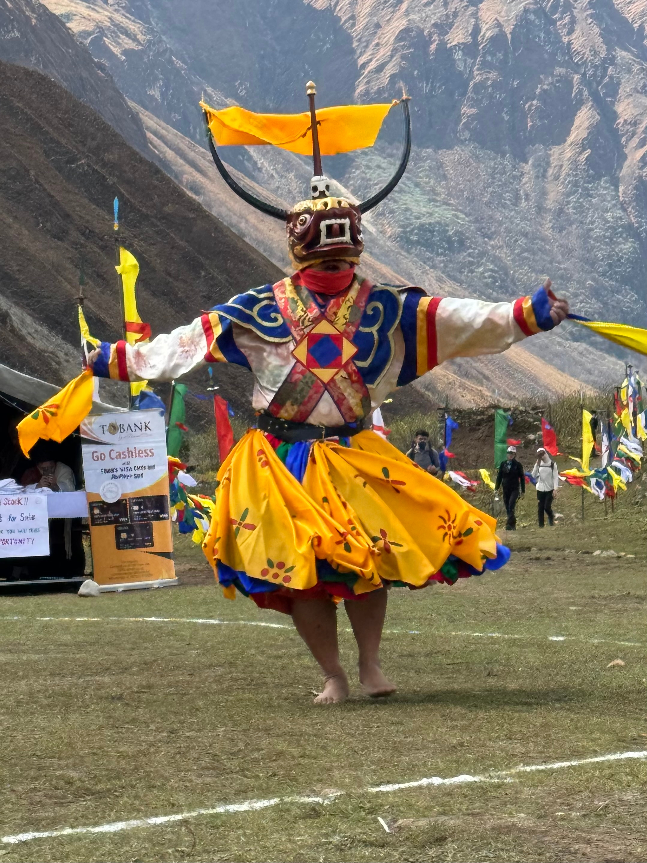 Man in traditional attire performing a cultural dance.