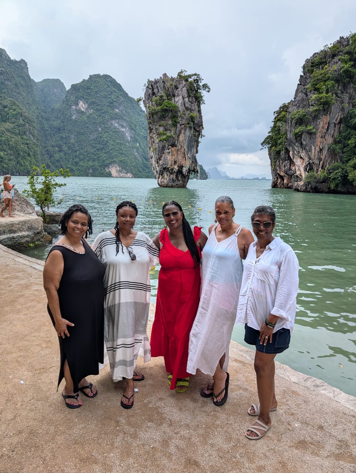 Group of women posing with James Bond Island in the background.