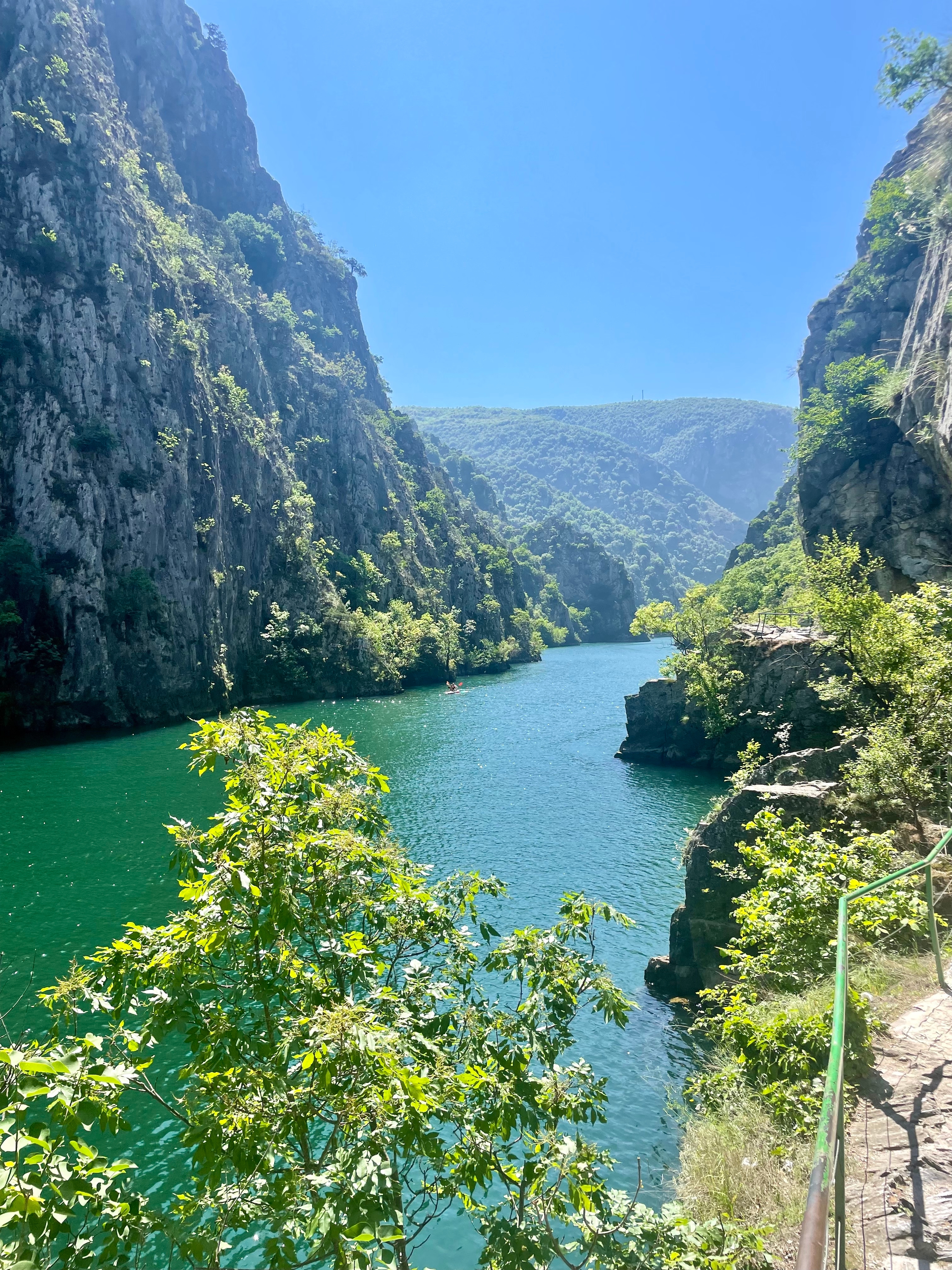 River gorge with deep green waters and steep cliffs.