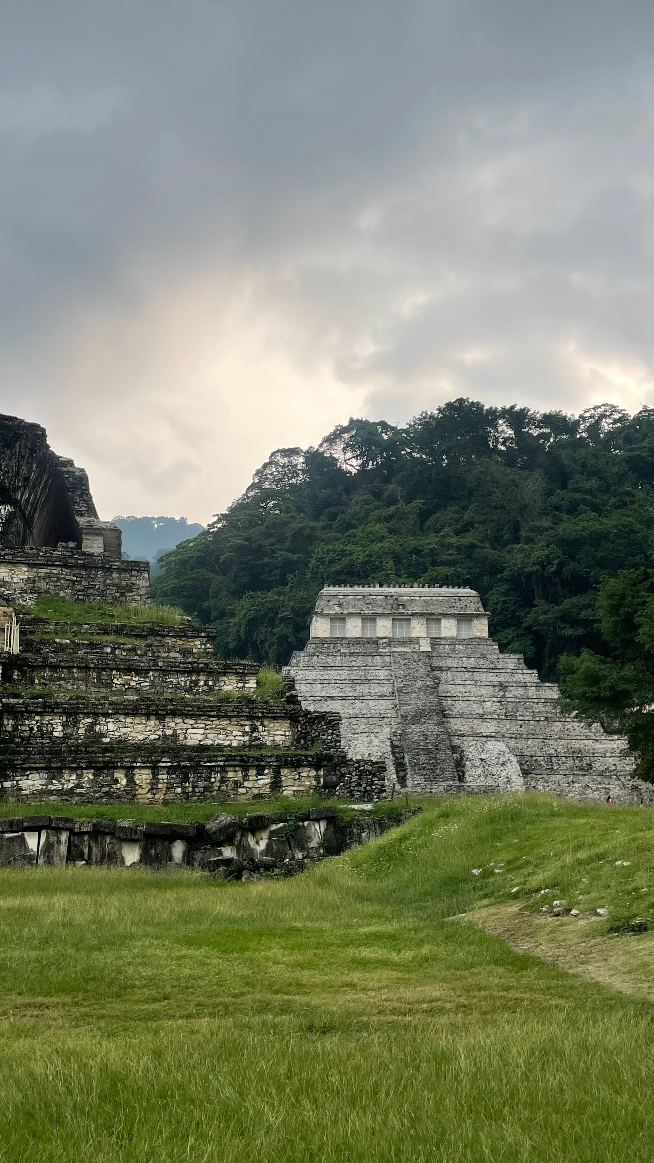 Ruins of an ancient stone temple surrounded by jungle.