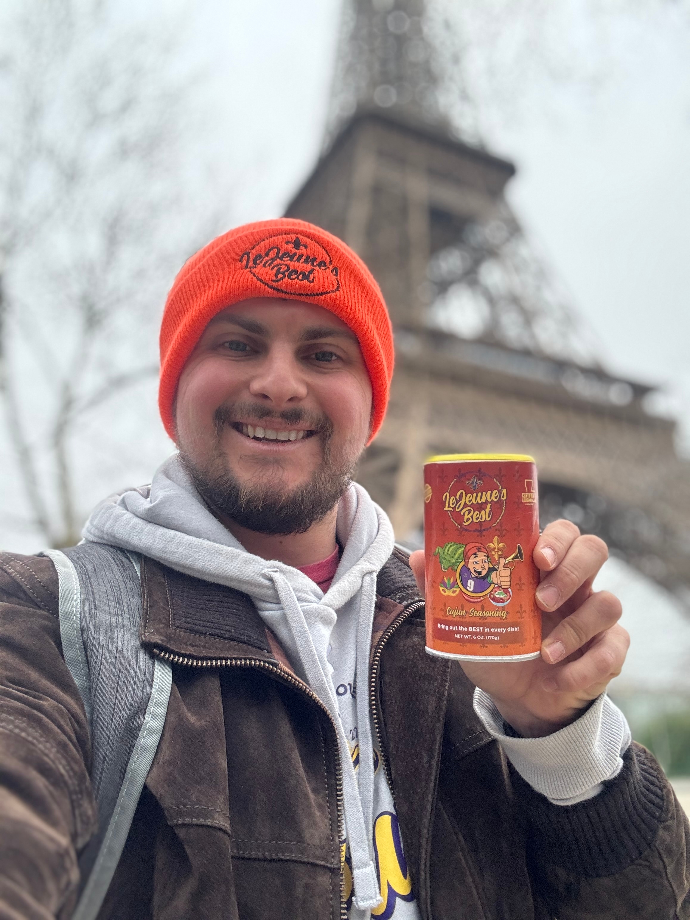 Person holding LeJeune's Best can with the Eiffel Tower in the background.