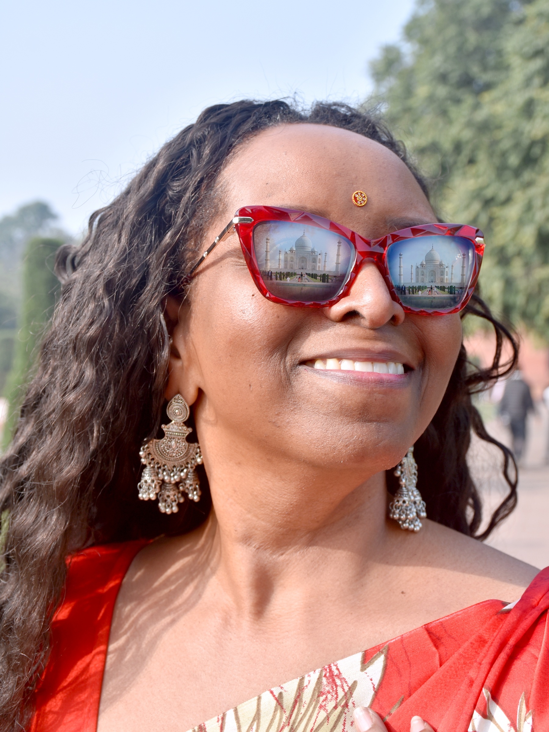 Close-up of sunglasses reflecting the Taj Mahal.