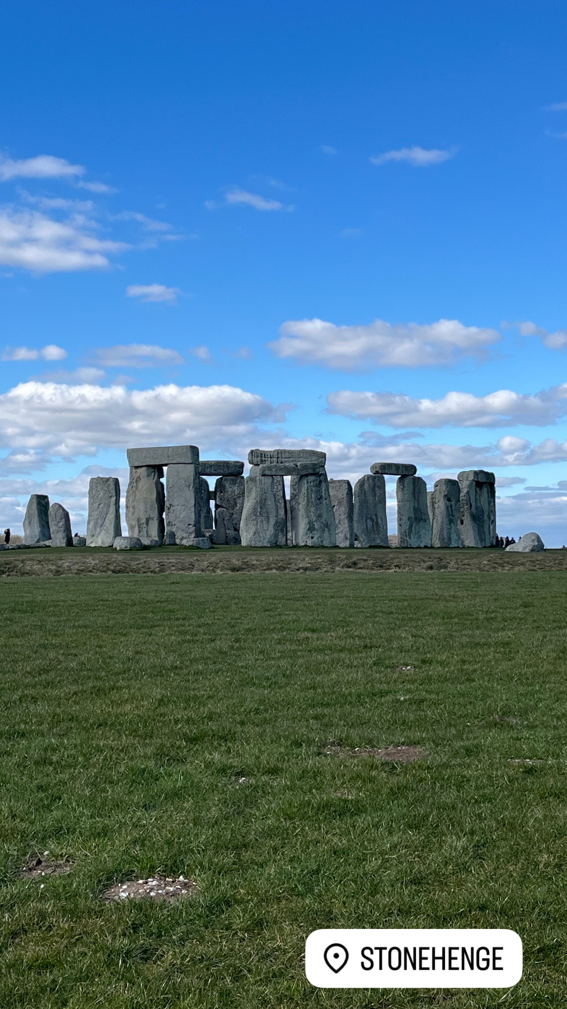 The iconic stone circle of Stonehenge under a clear sky.