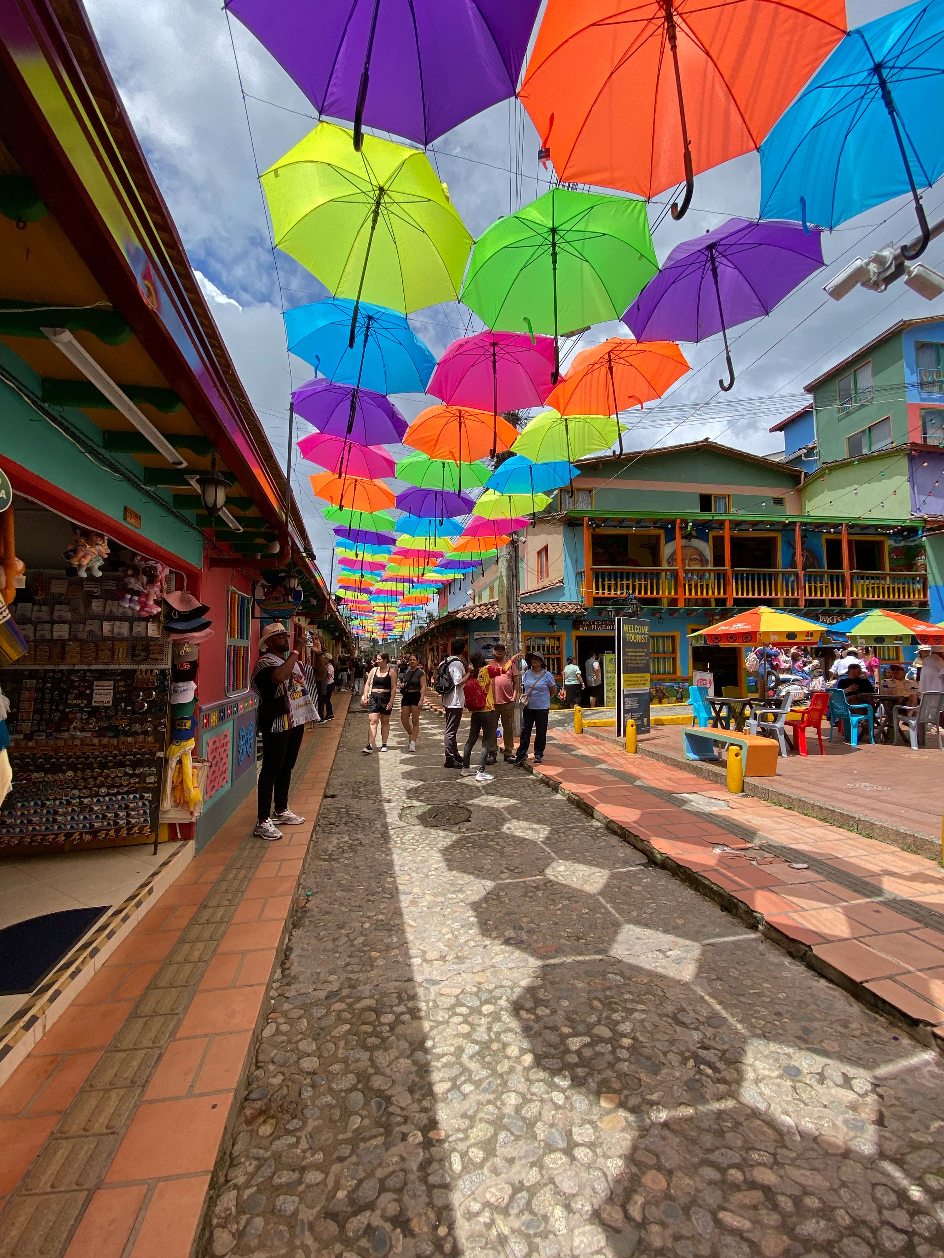 Colorful street with hanging umbrellas.
