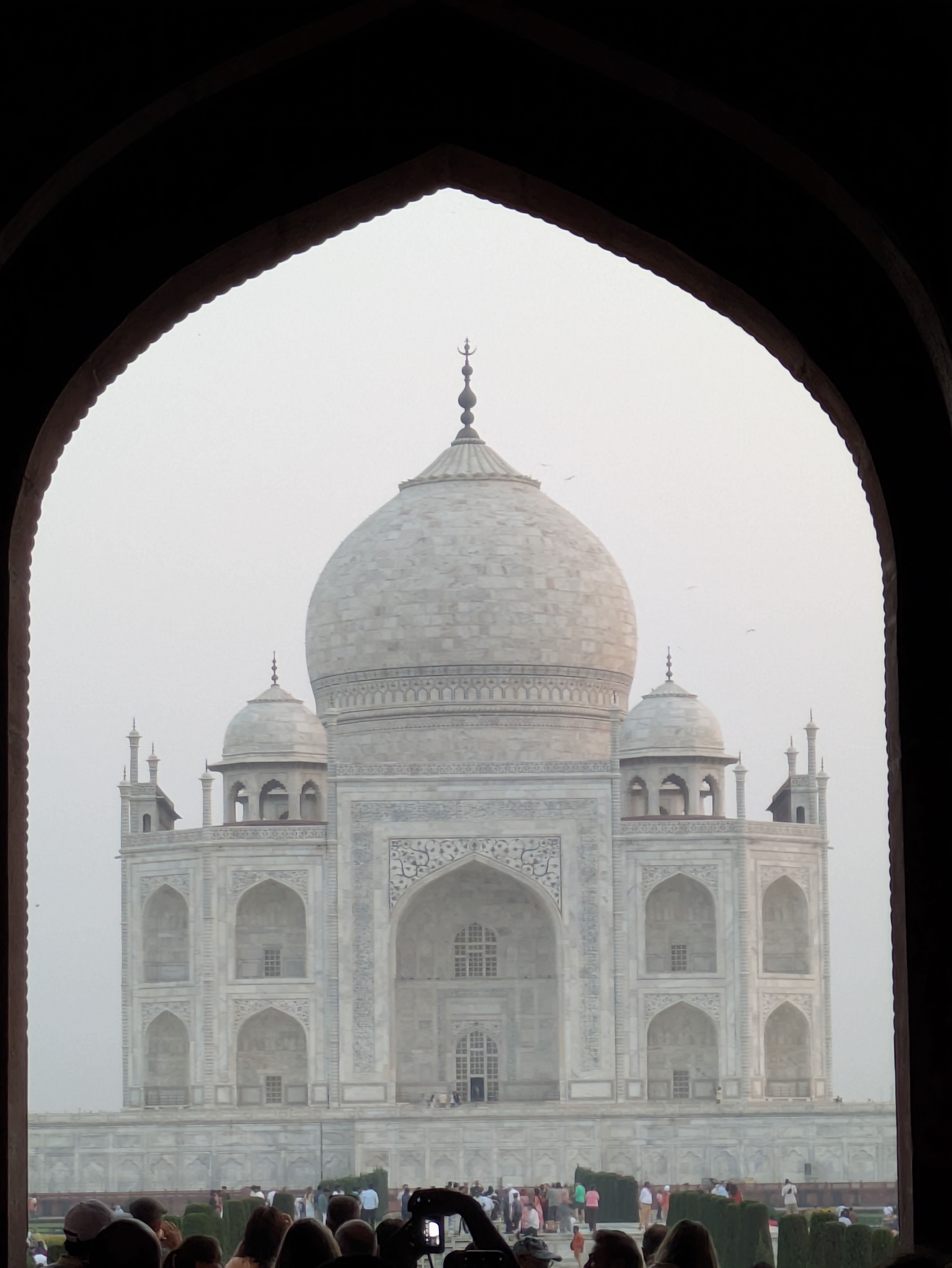 Close-up of the Taj Mahal dome framed by an arch.